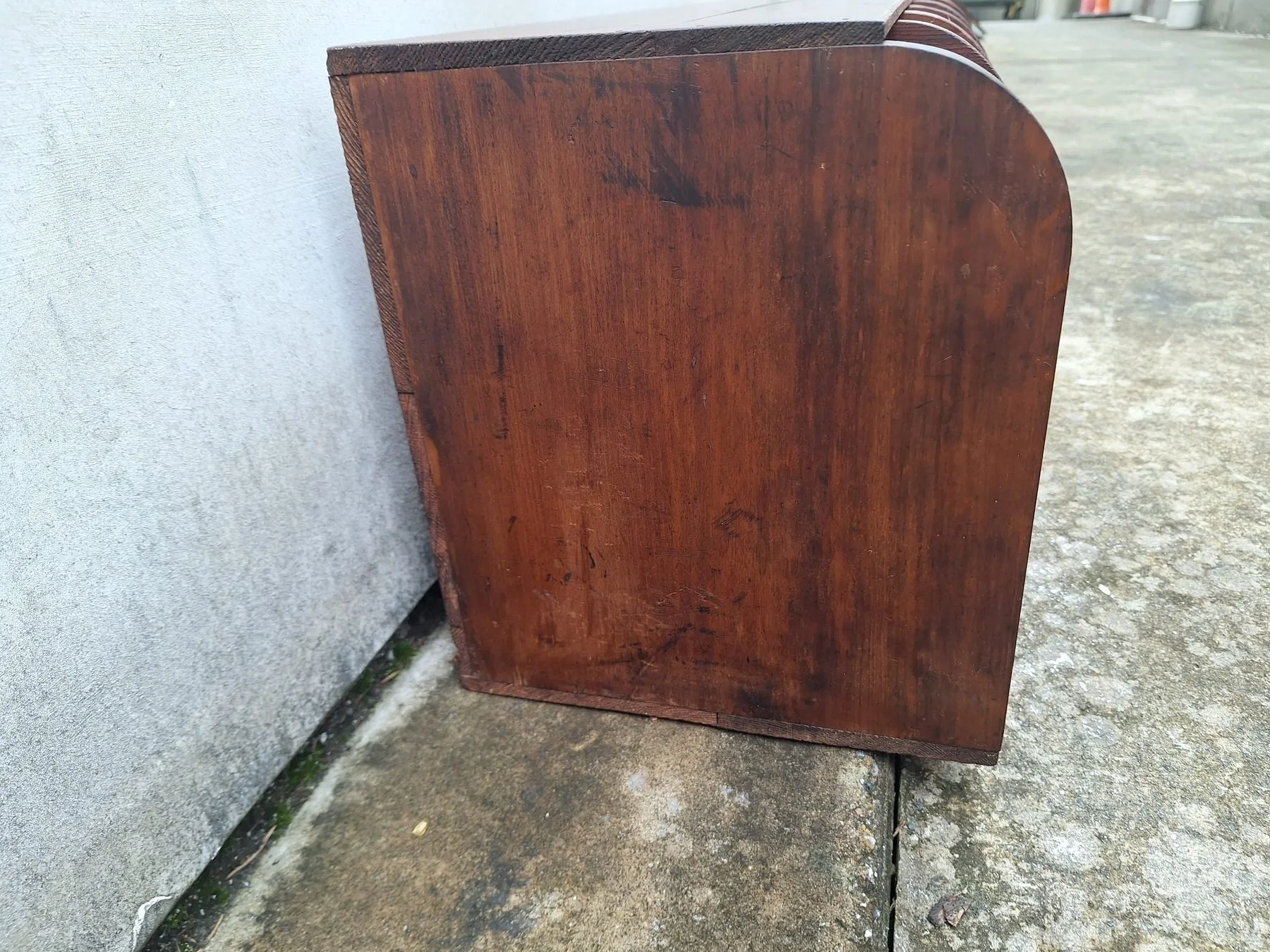 Antique timber letter holder with divided compartments and curved sides.