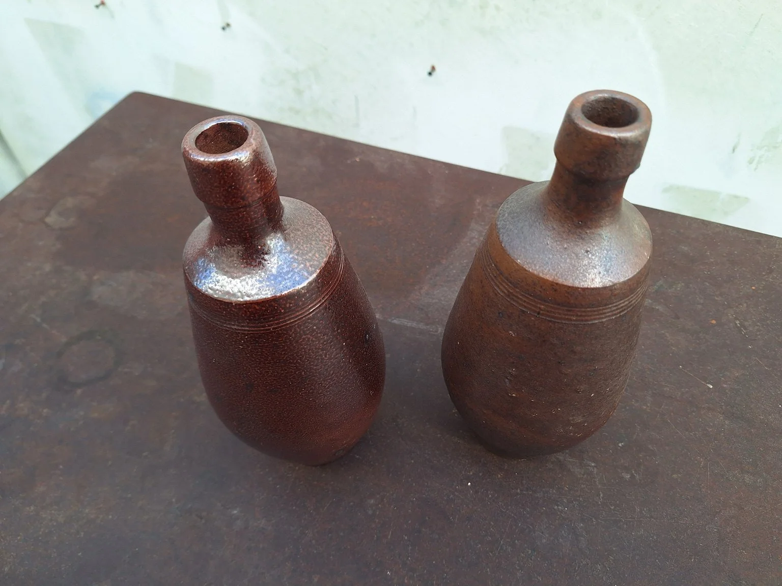 Overhead view showing the narrow openings and glazed necks of both vases.