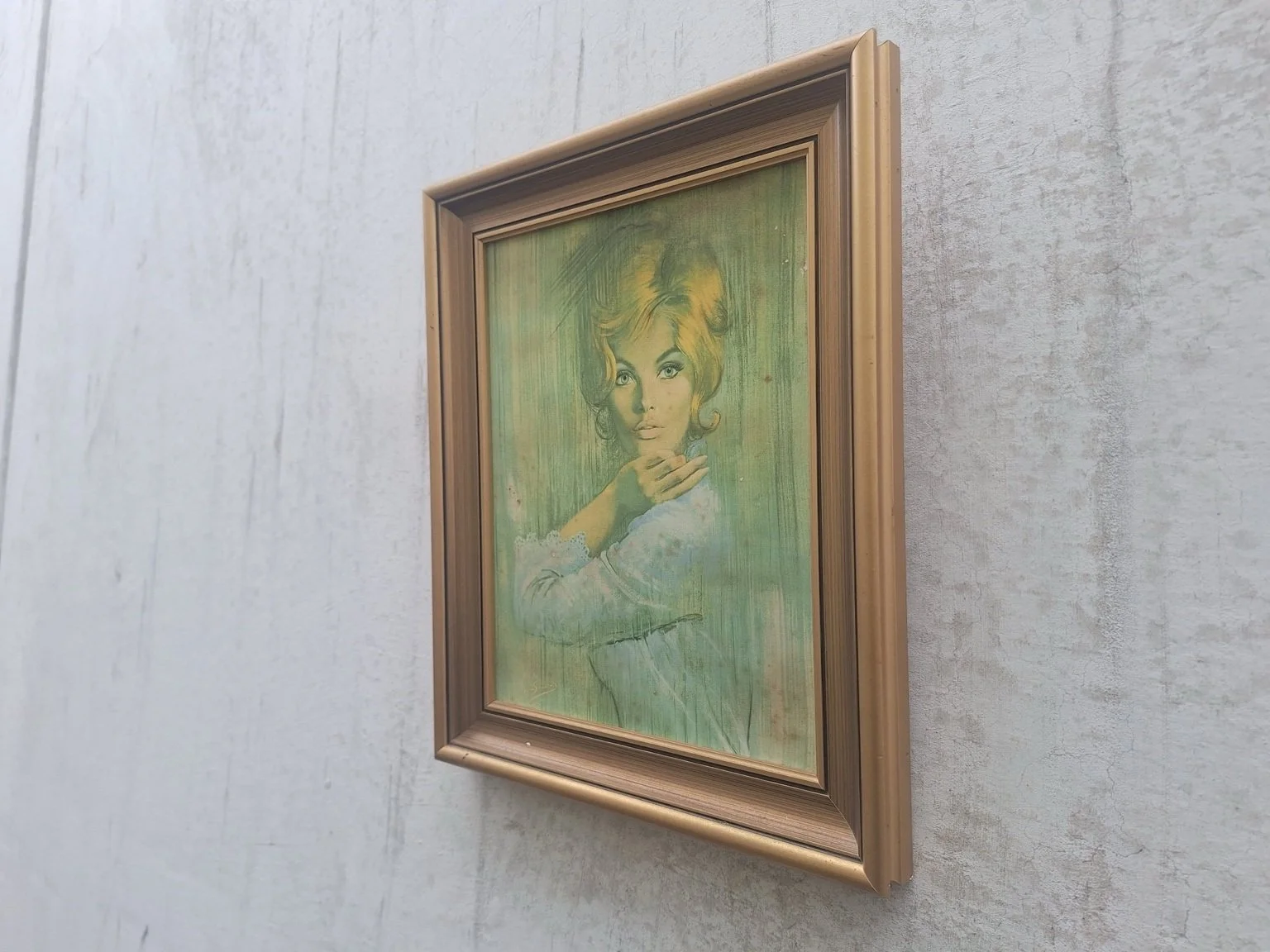 Angled view of the portrait print showing the depth and gold-tone frame.