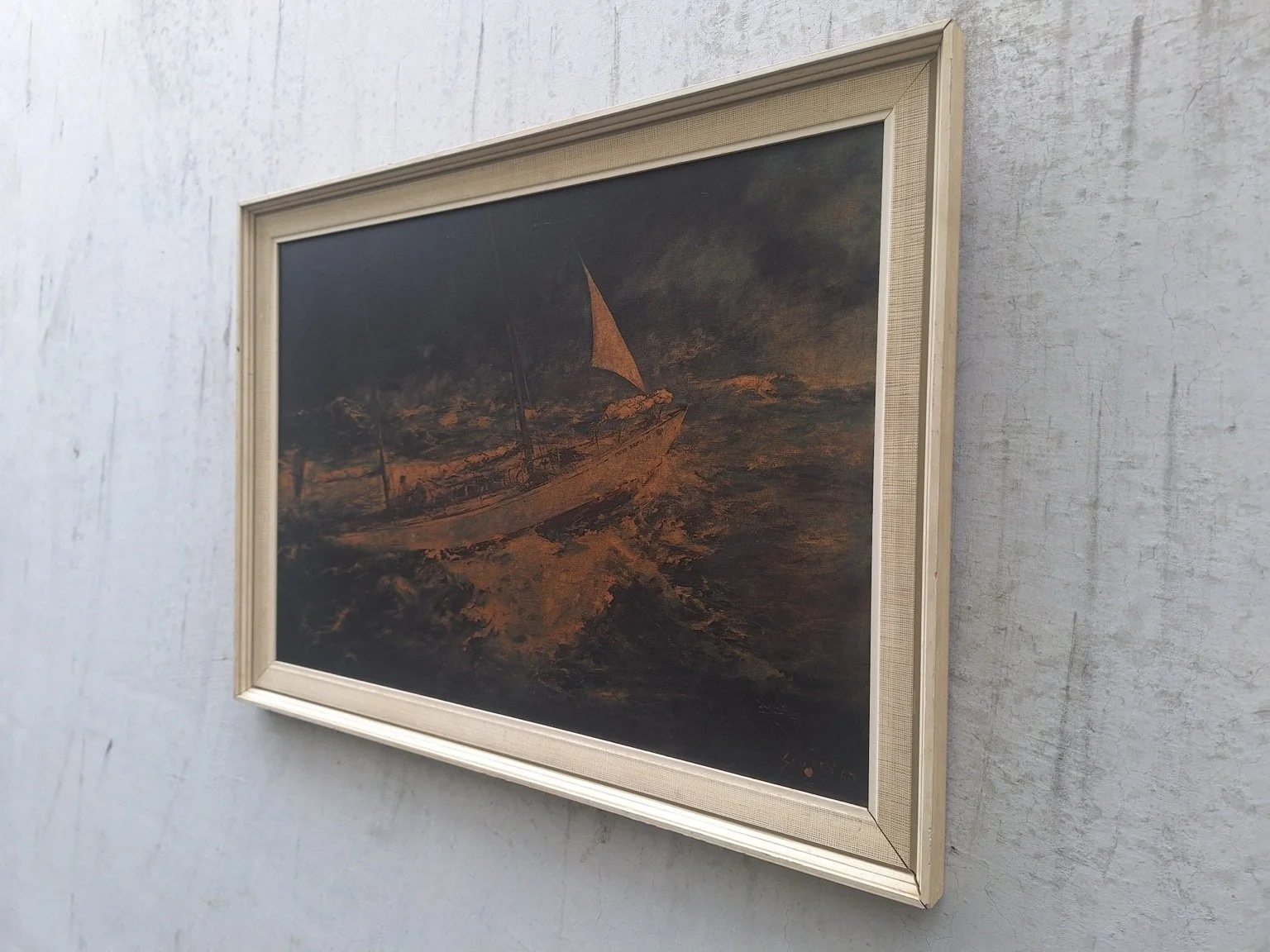 Left angled view showing the maritime print and the profile of its pale frame.