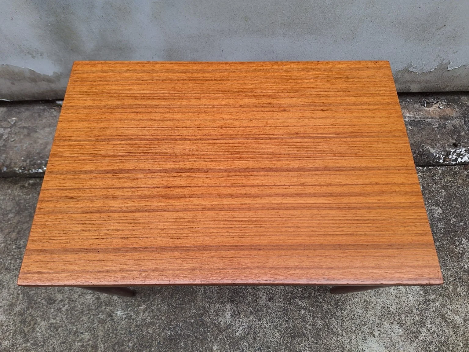 Overhead view of the veneered top showing grain and light surface marks.
