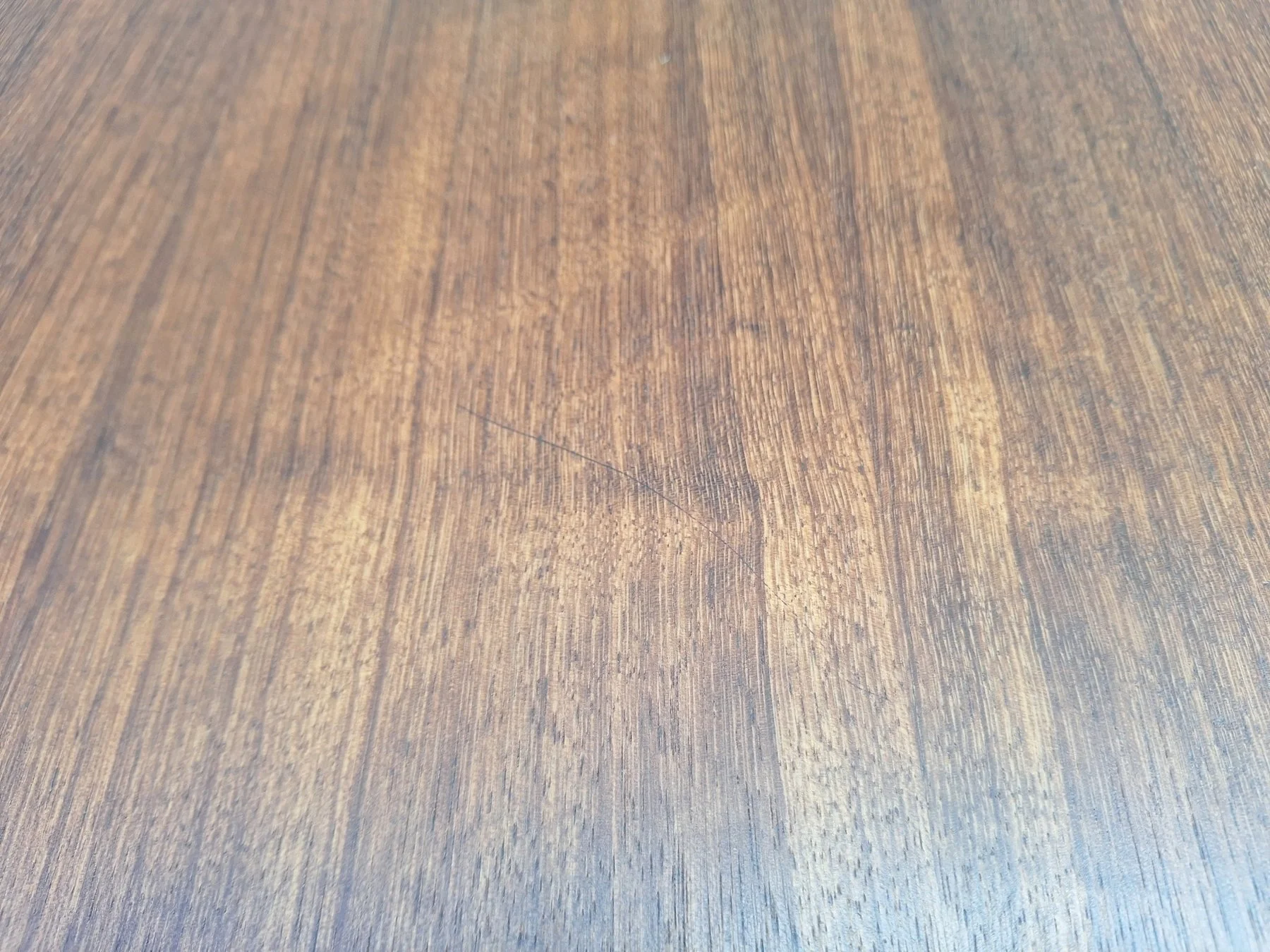 Detailed view of the professionally restored blackbean tabletop surface.