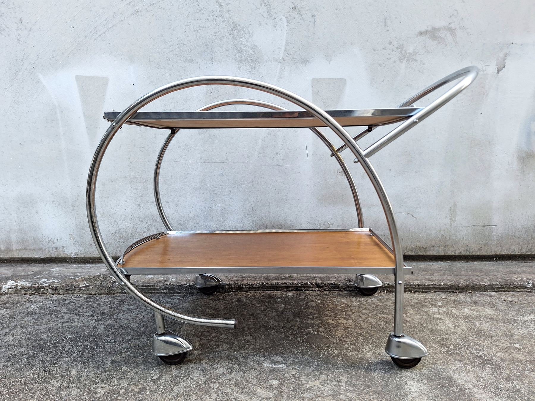 Side profile of Ranleigh chrome drinks trolley with two ply shelves