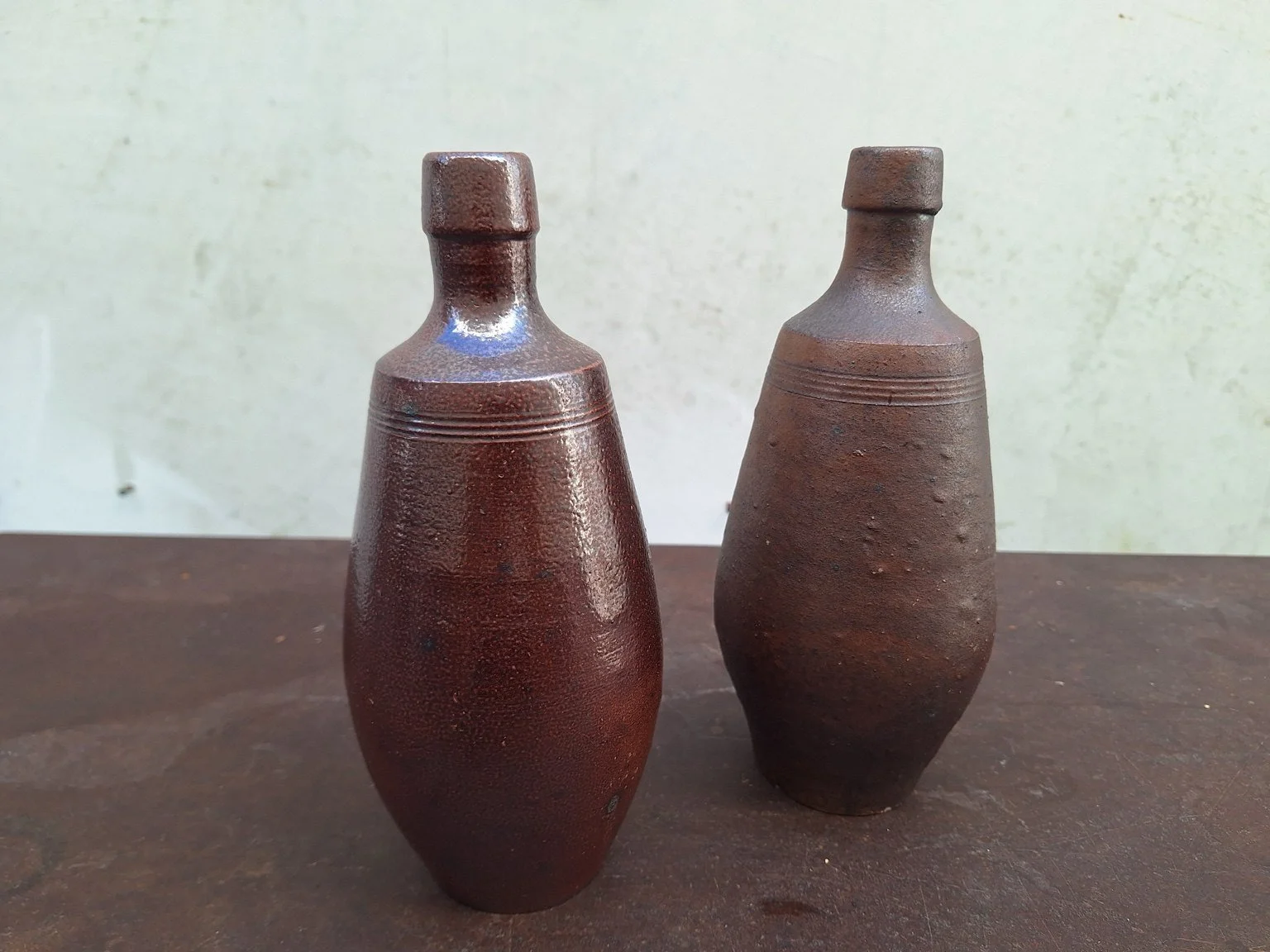 Two Portuguese ceramic bottle vases showing individual forms and glaze variation.