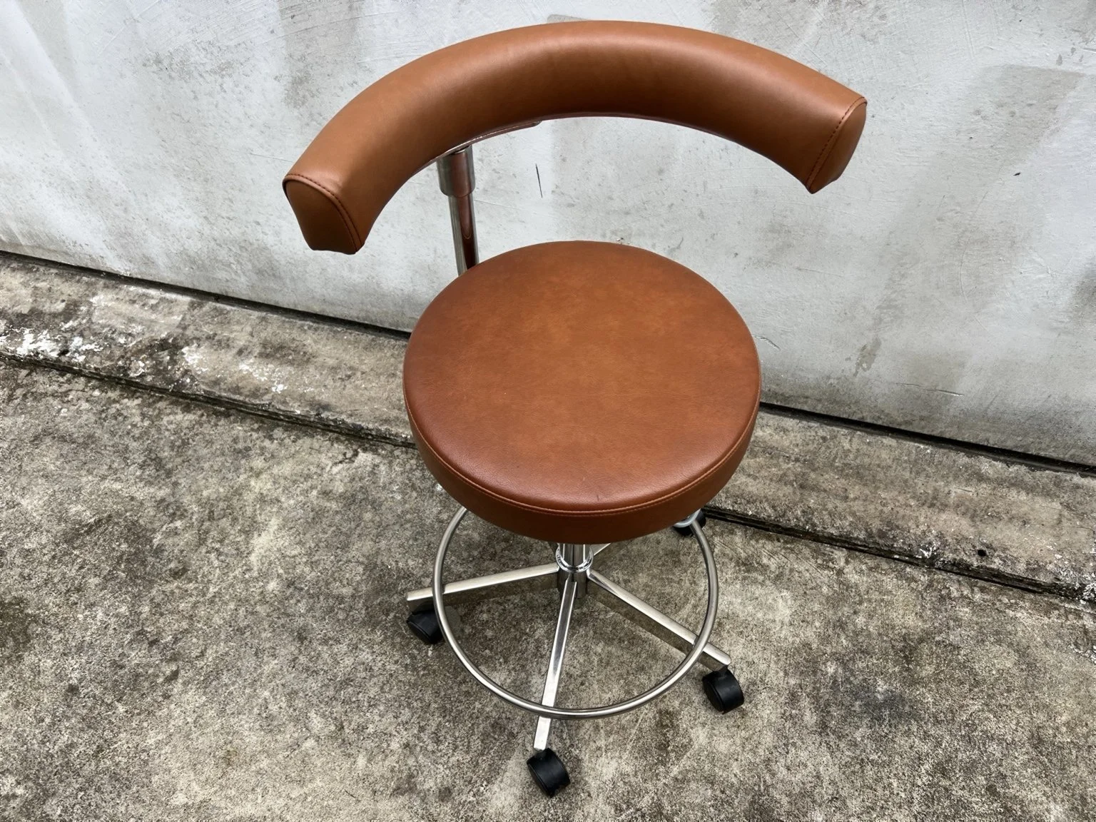 Mid century adjustable stool with tan leather seat and chrome base