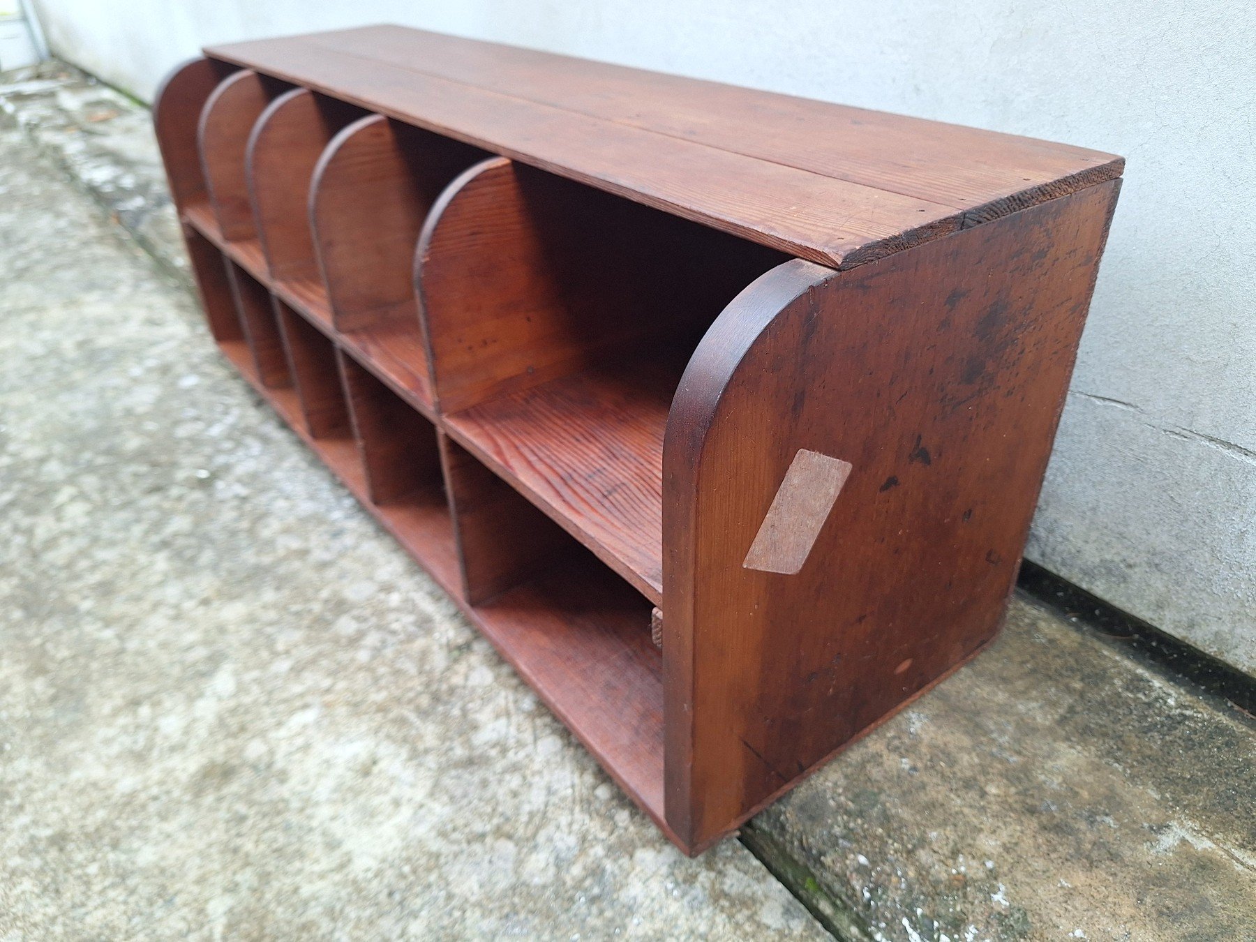 Antique timber letter holder with divided compartments and curved sides.