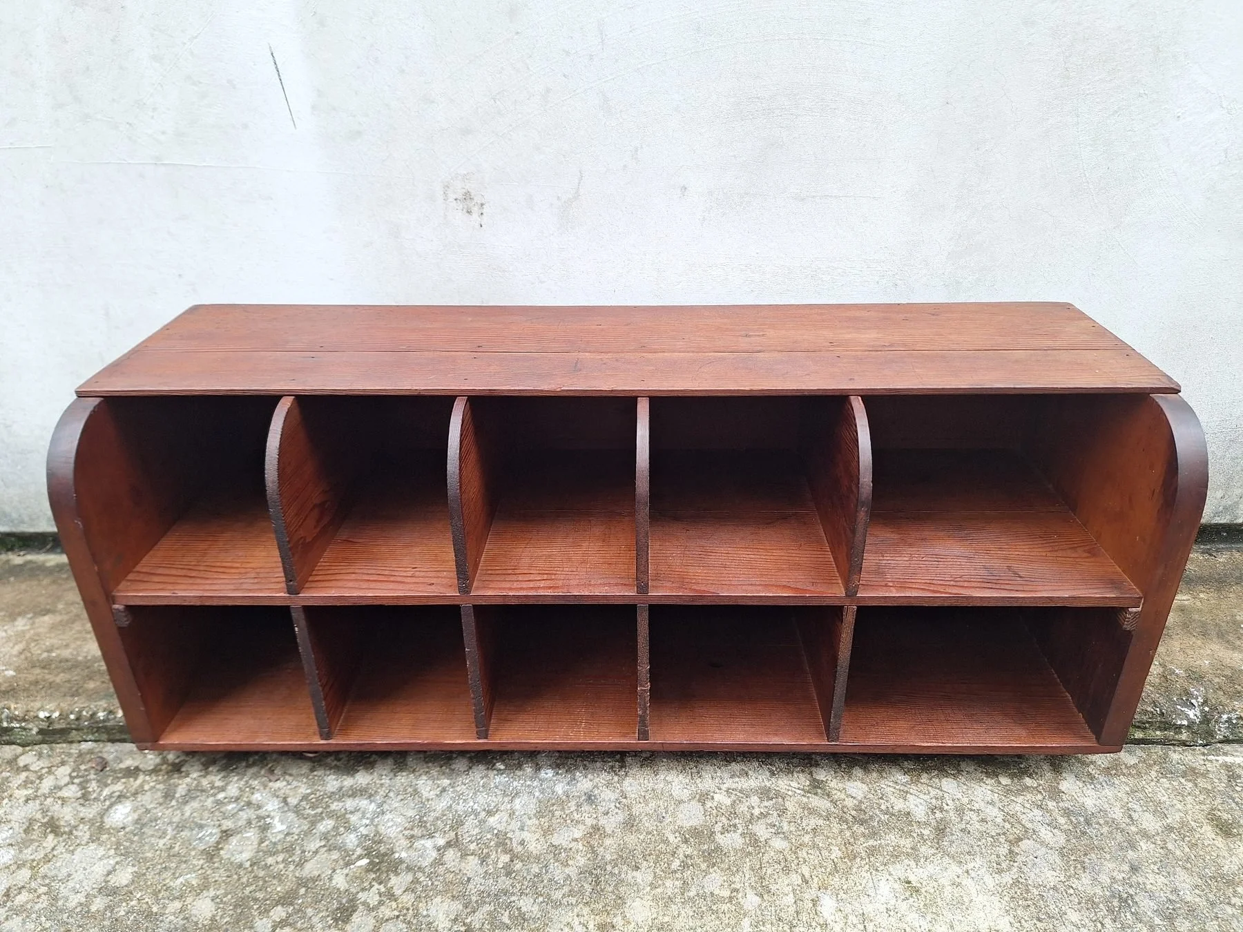 Antique timber letter holder with divided compartments and curved sides.