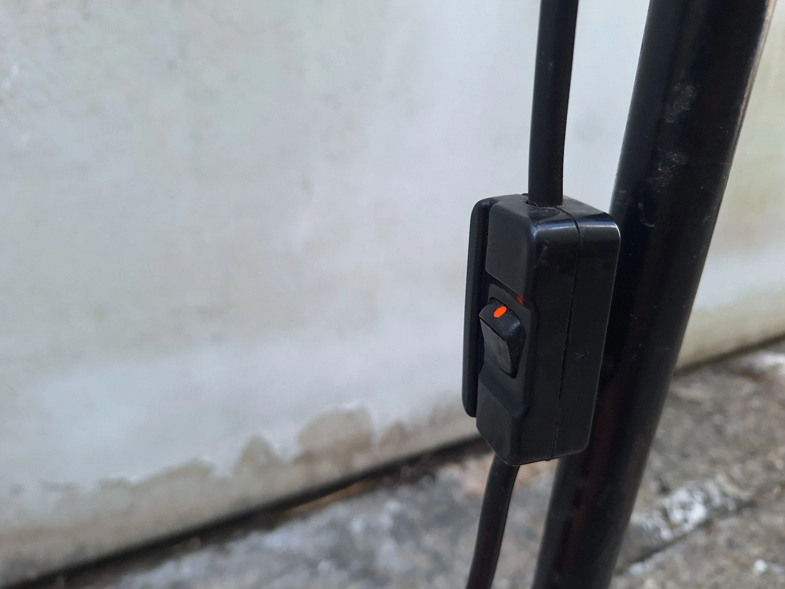 Inline switch on the power cable beside the stand of lamp No. 1.