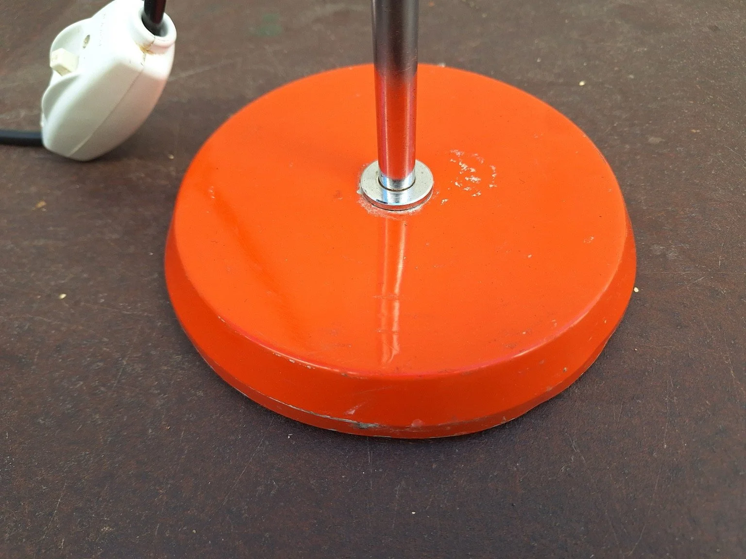 Orange circular base showing vintage condition and paint wear
