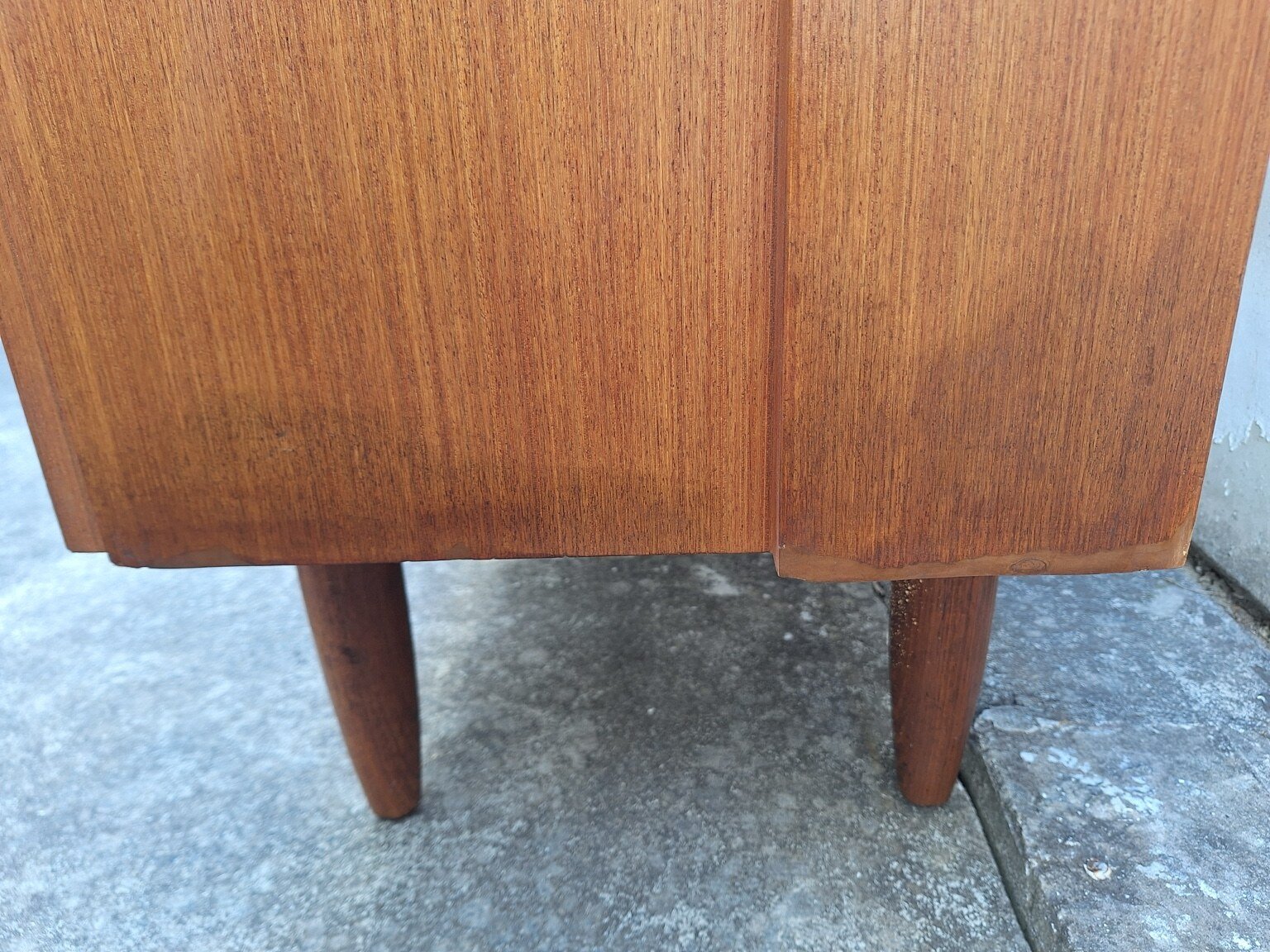 Visible previous repair near the lower edge and tapered legs of the vintage wall unit
