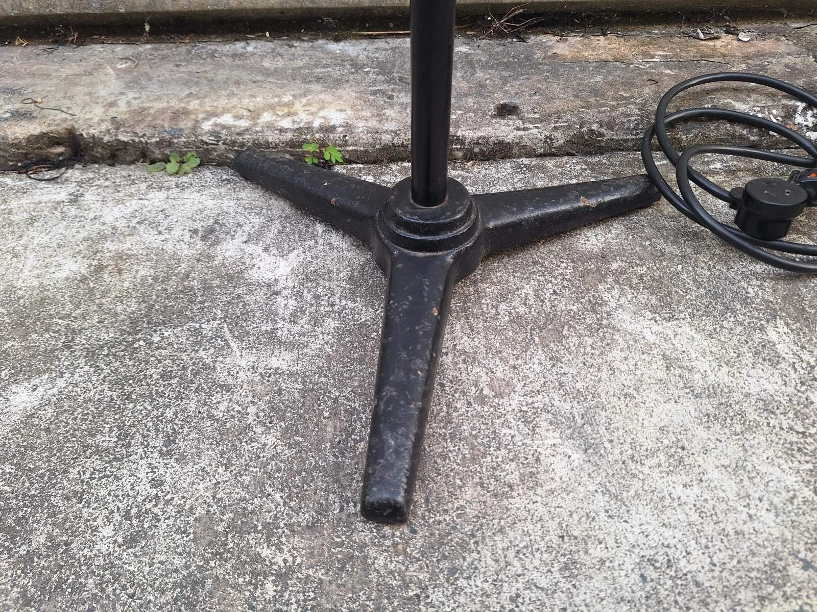 Three-foot black stand base of lamp No. 2 with visible age-related surface wear.