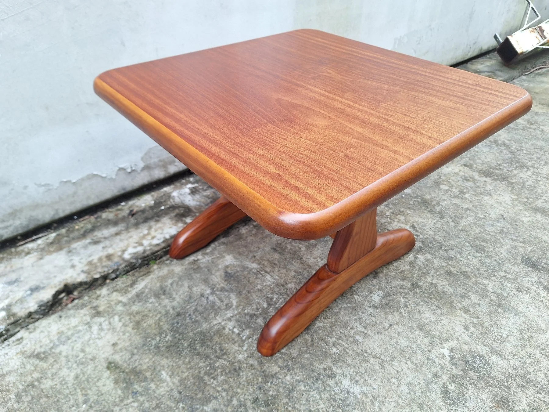 Vintage square timber coffee table with rounded edges and sculptural pedestal base.