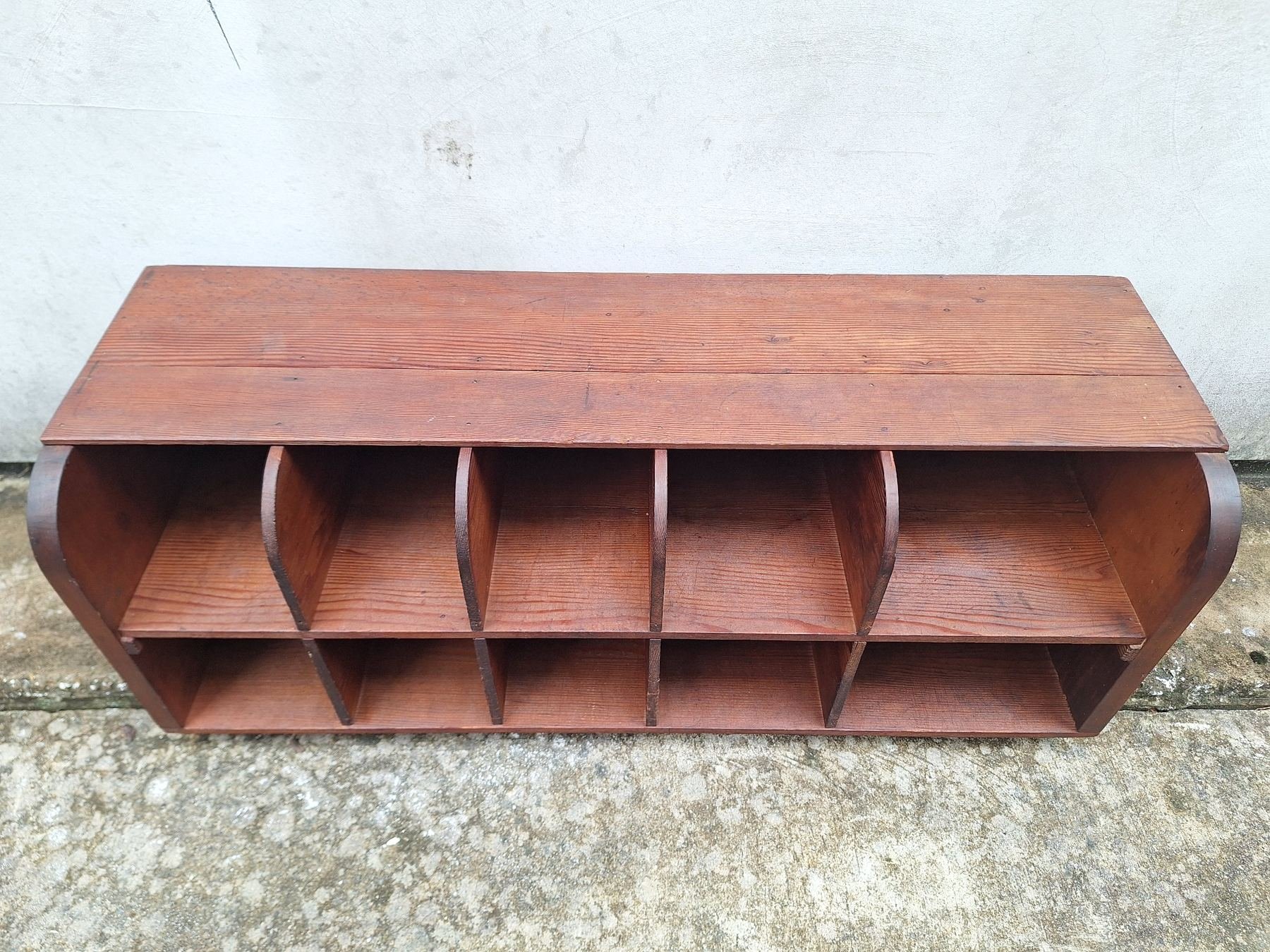 Antique timber letter holder with divided compartments and curved sides.