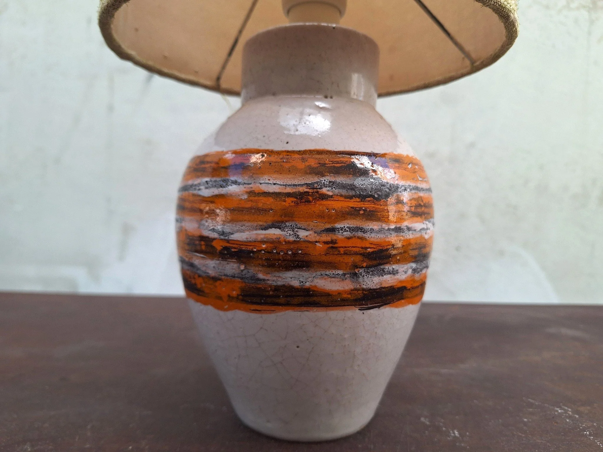 Vintage Bitossi ceramic table lamp with textured off white glaze, orange and charcoal banding, woven shade and braided cord.