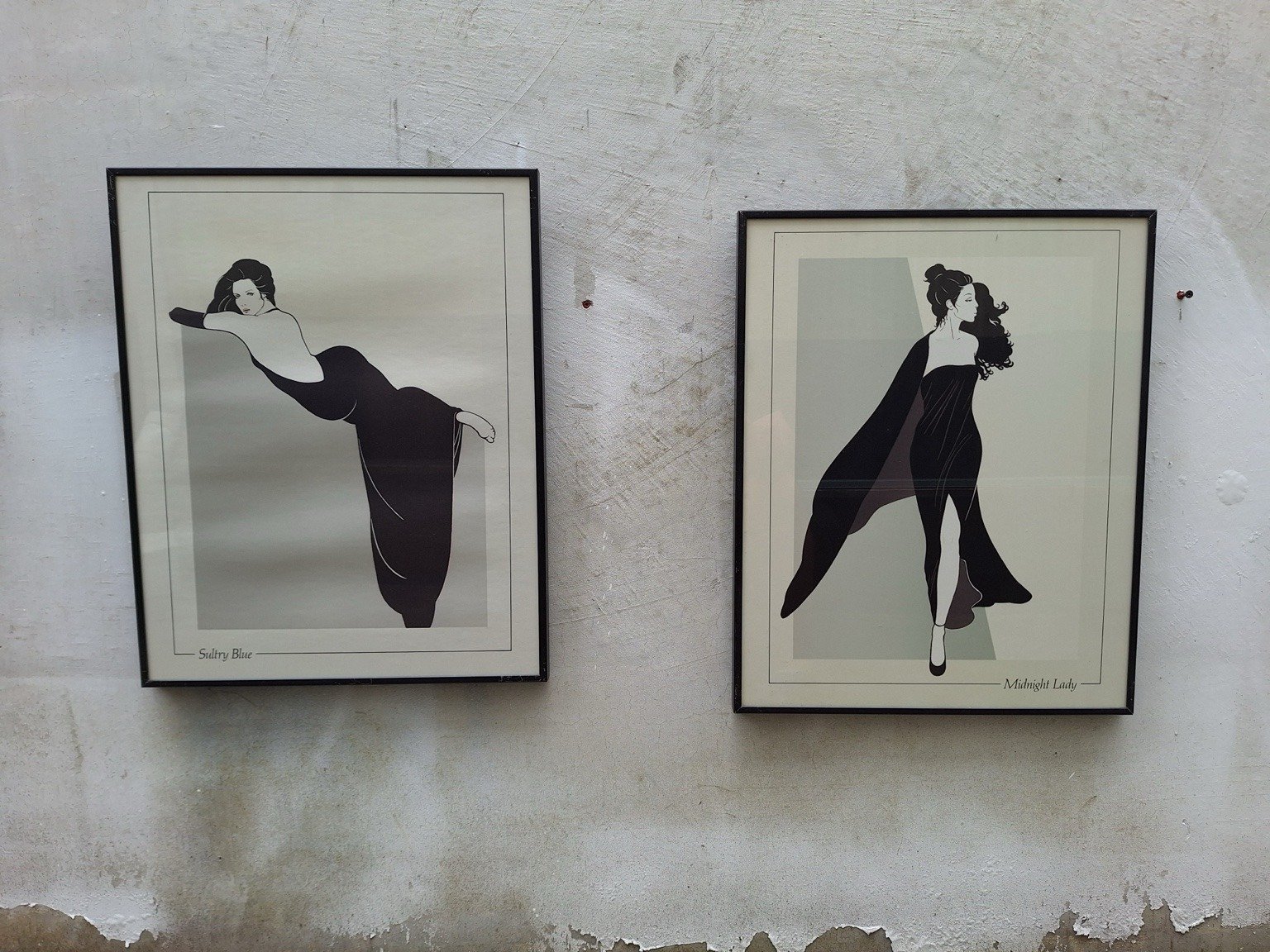 Pair of framed Sultry Blue and Midnight Lady fashion prints displayed side by side.