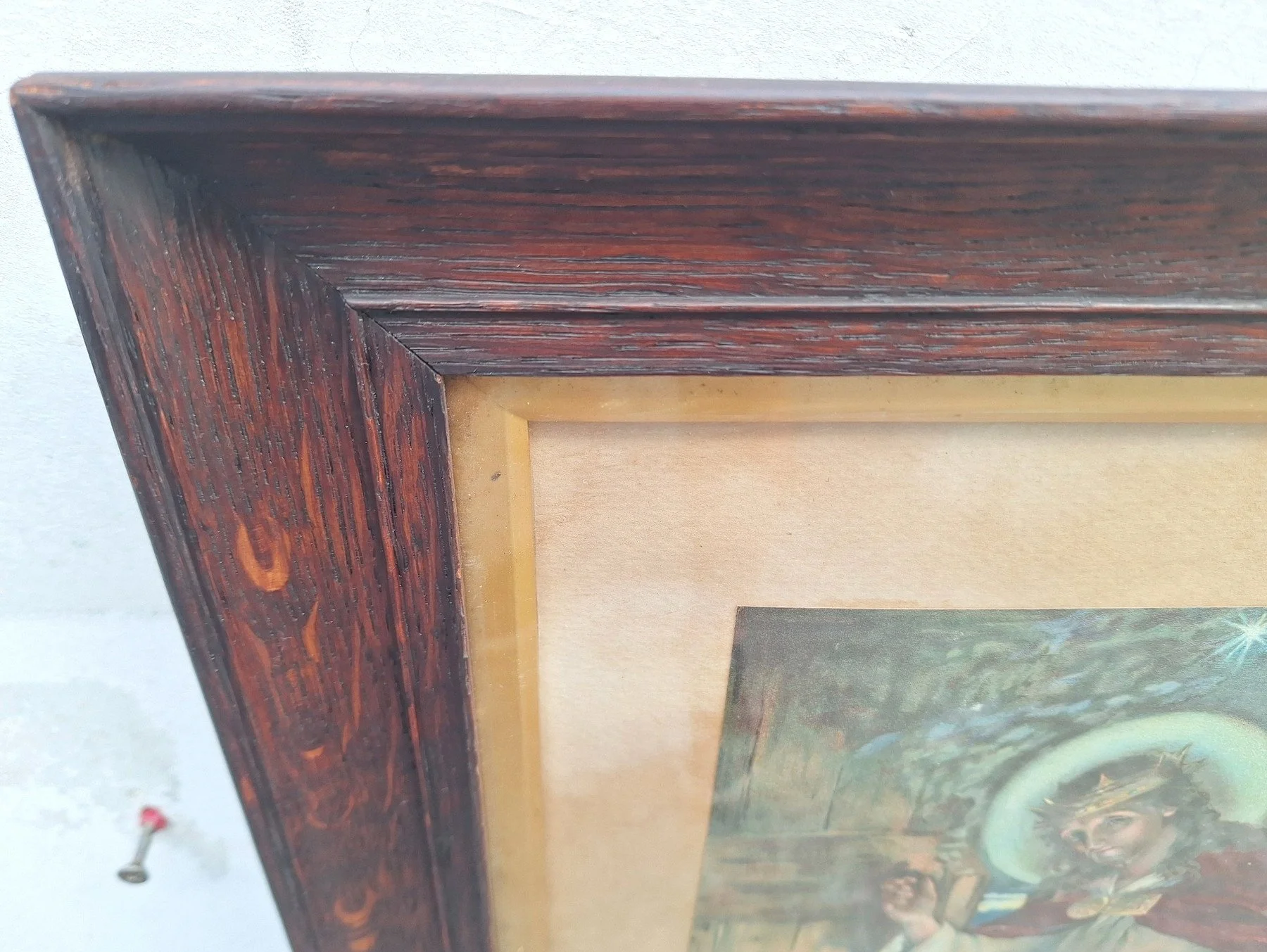 Close-up of figured silky oak frame surrounding a vintage Jesus print