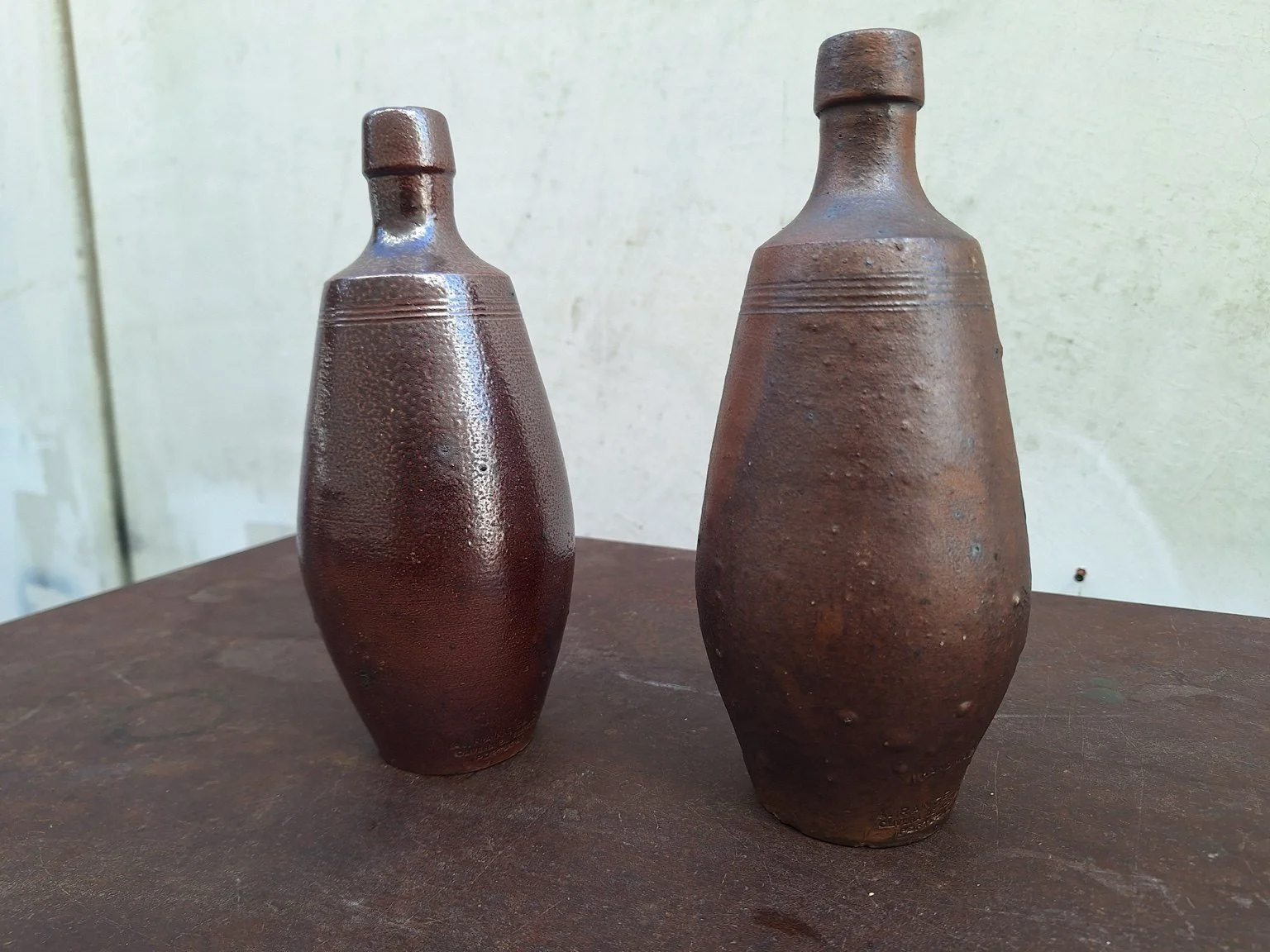 Reverse view of the pair of A. Evangelista ceramic bottle vases.