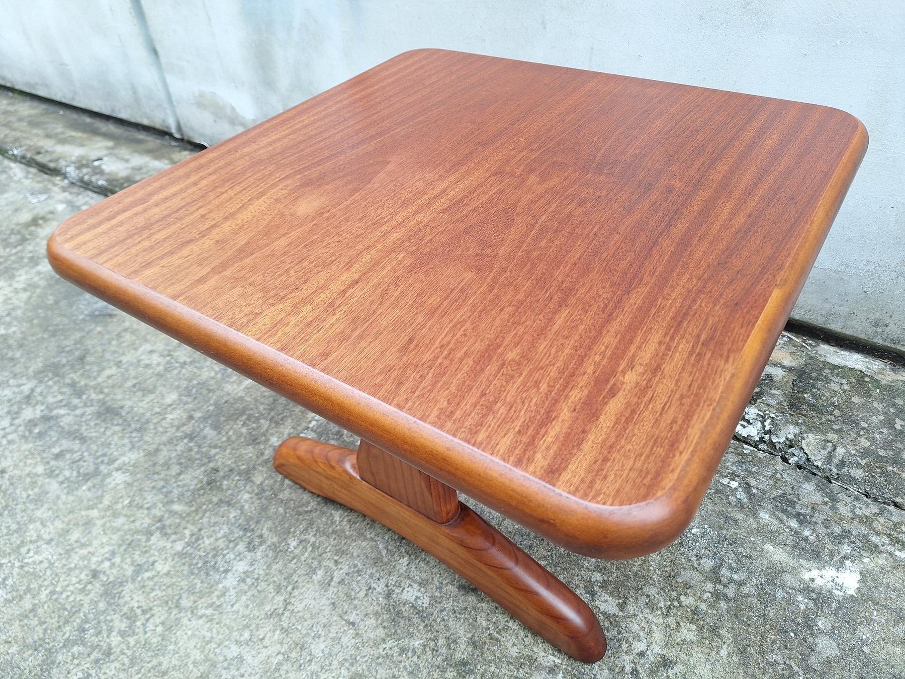 Vintage square timber coffee table with rounded edges and sculptural pedestal base.