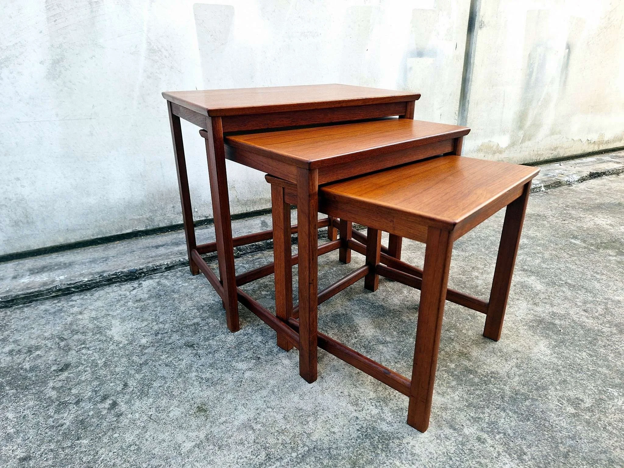 teak nesting tables angled view