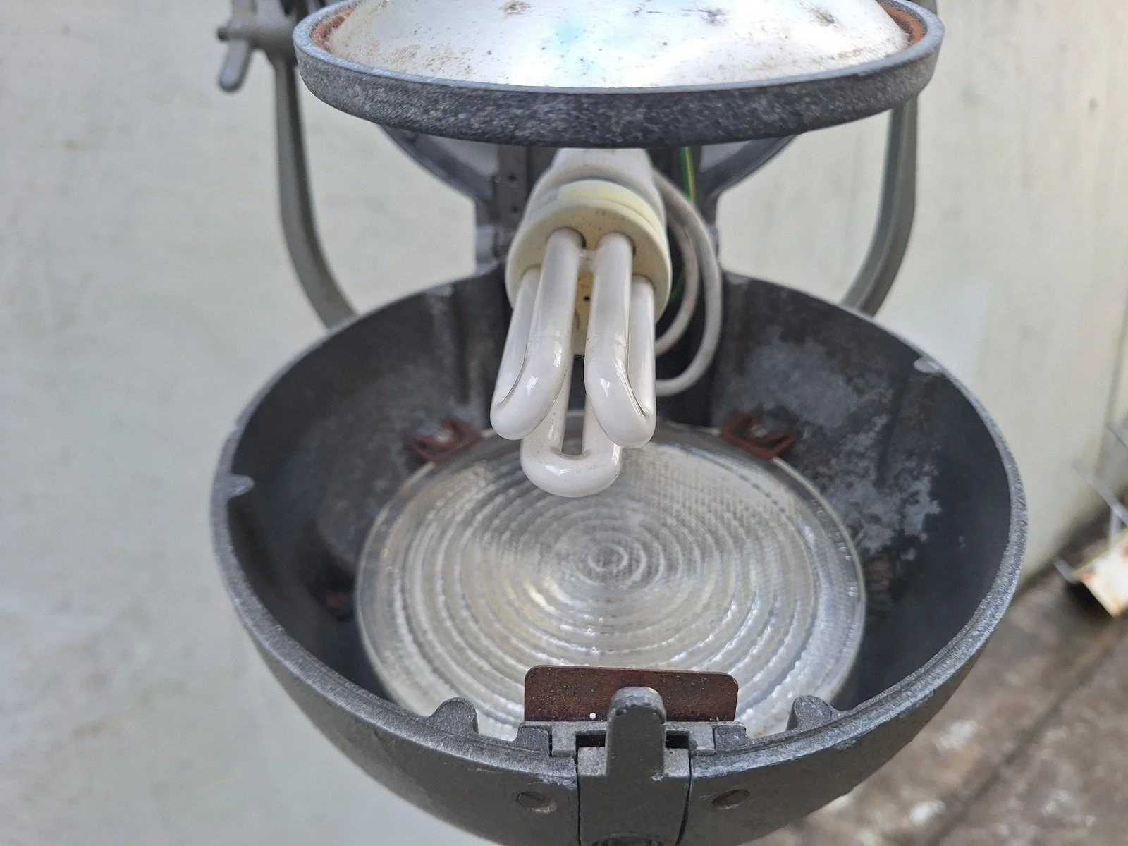 Open housing of lamp No. 2 showing its converted bulb fitting, globe and glass lens.