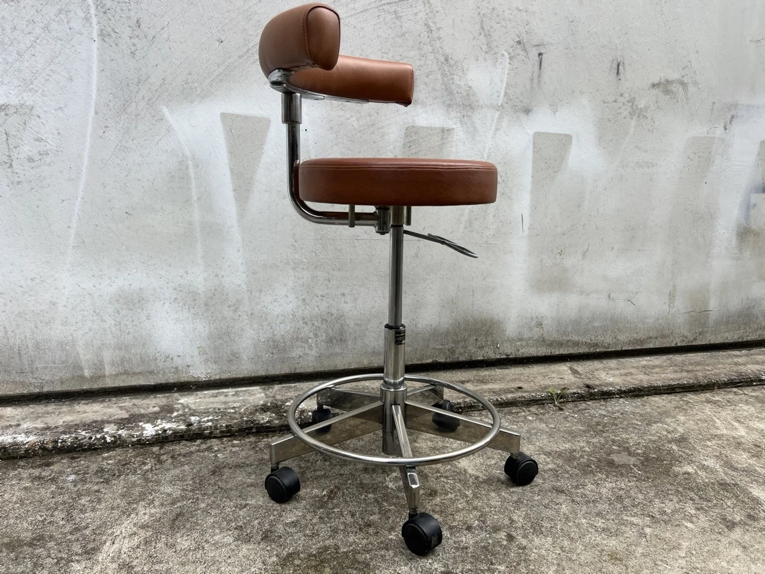 Mid century adjustable stool with tan leather seat and chrome base