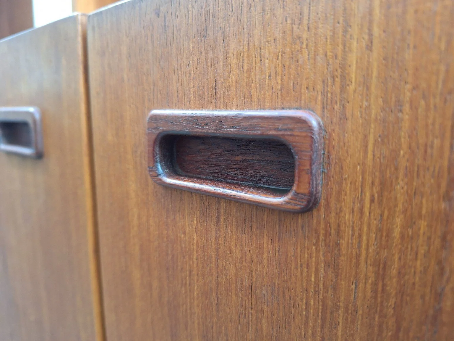 Recessed timber pull detail on the vintage wall unit cabinetry