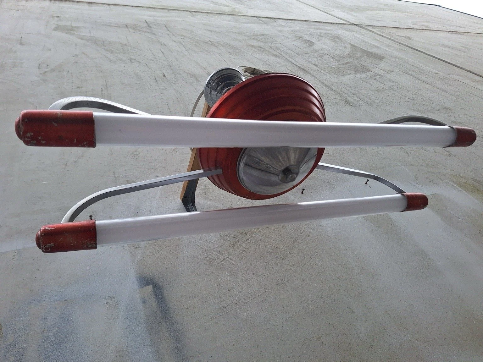 Underside view of the vintage ceiling light showing its central metal cover and twin LED tubes.