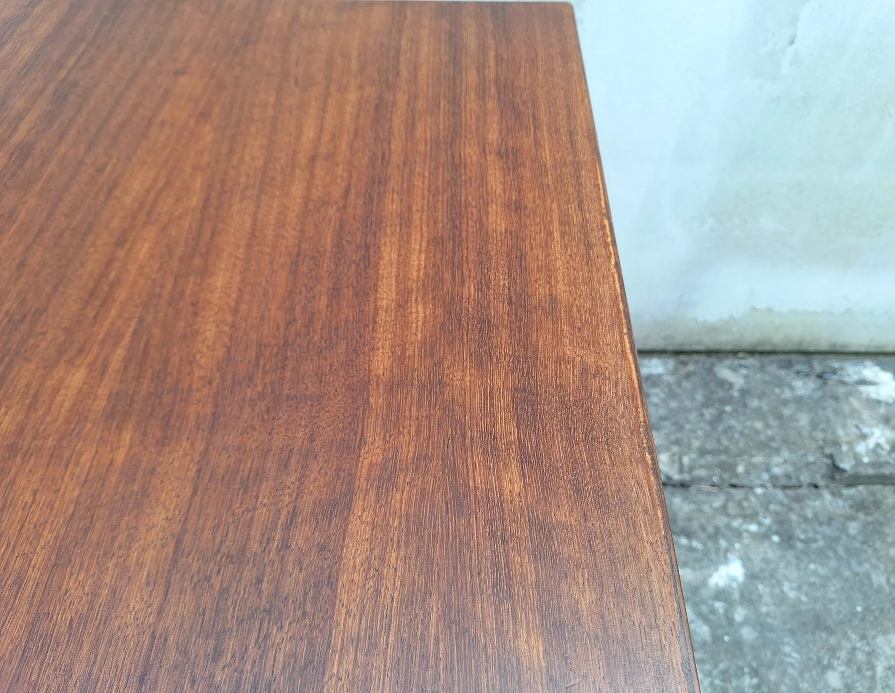 Close-up of the restored blackbean timber grain on the DQF dining table.
