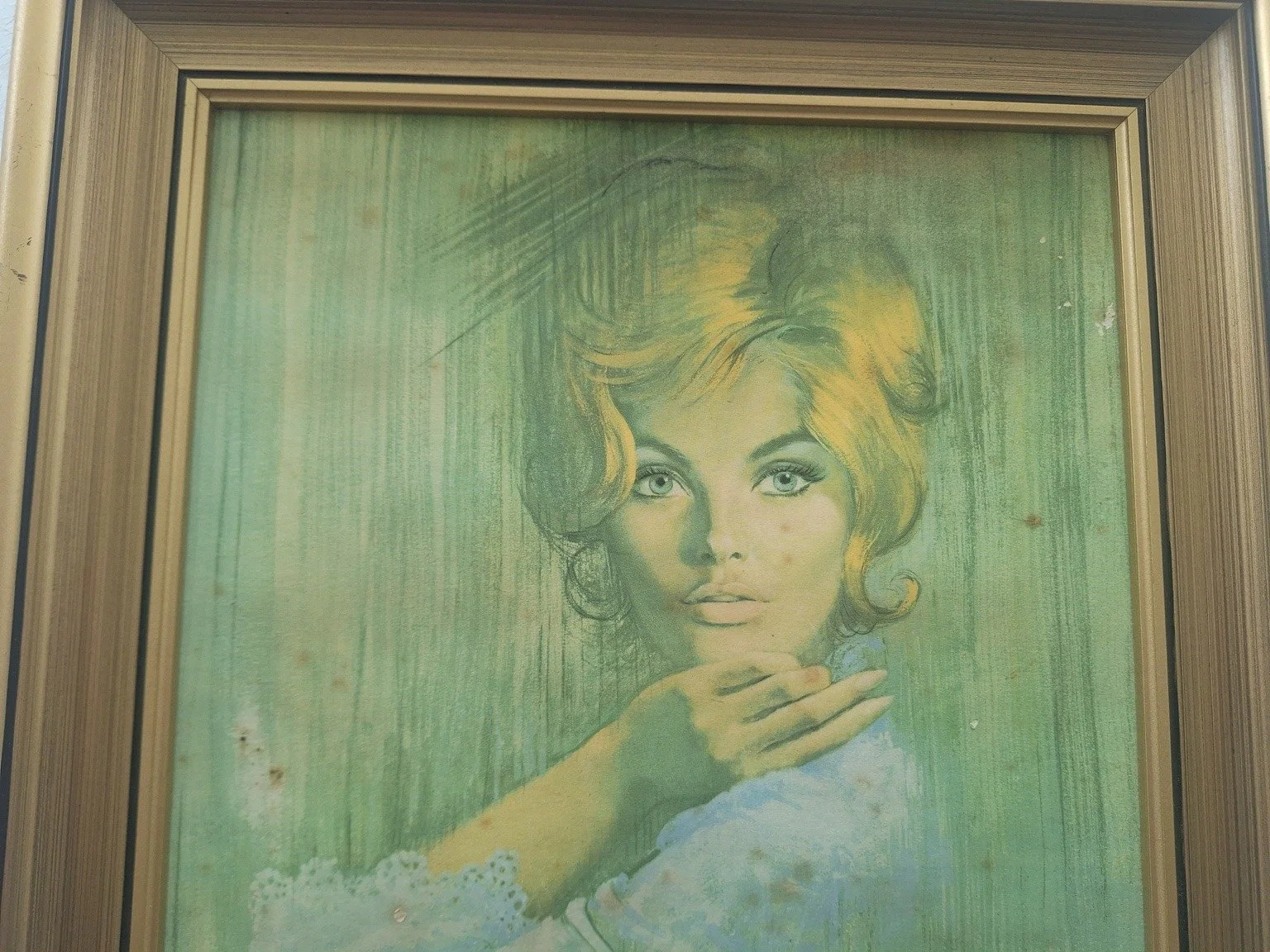 Close view of the blonde portrait and green background showing spotting and small surface losses.