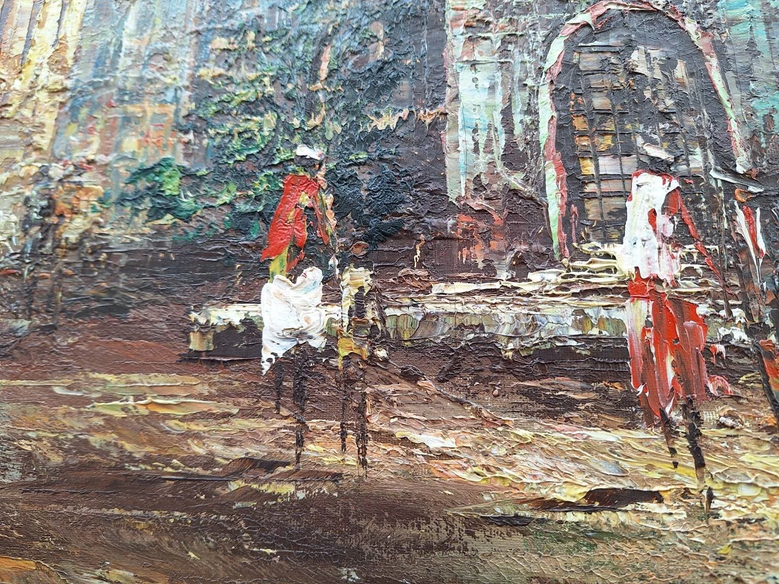Close detail of painted figures and architectural elements within the European street scene.