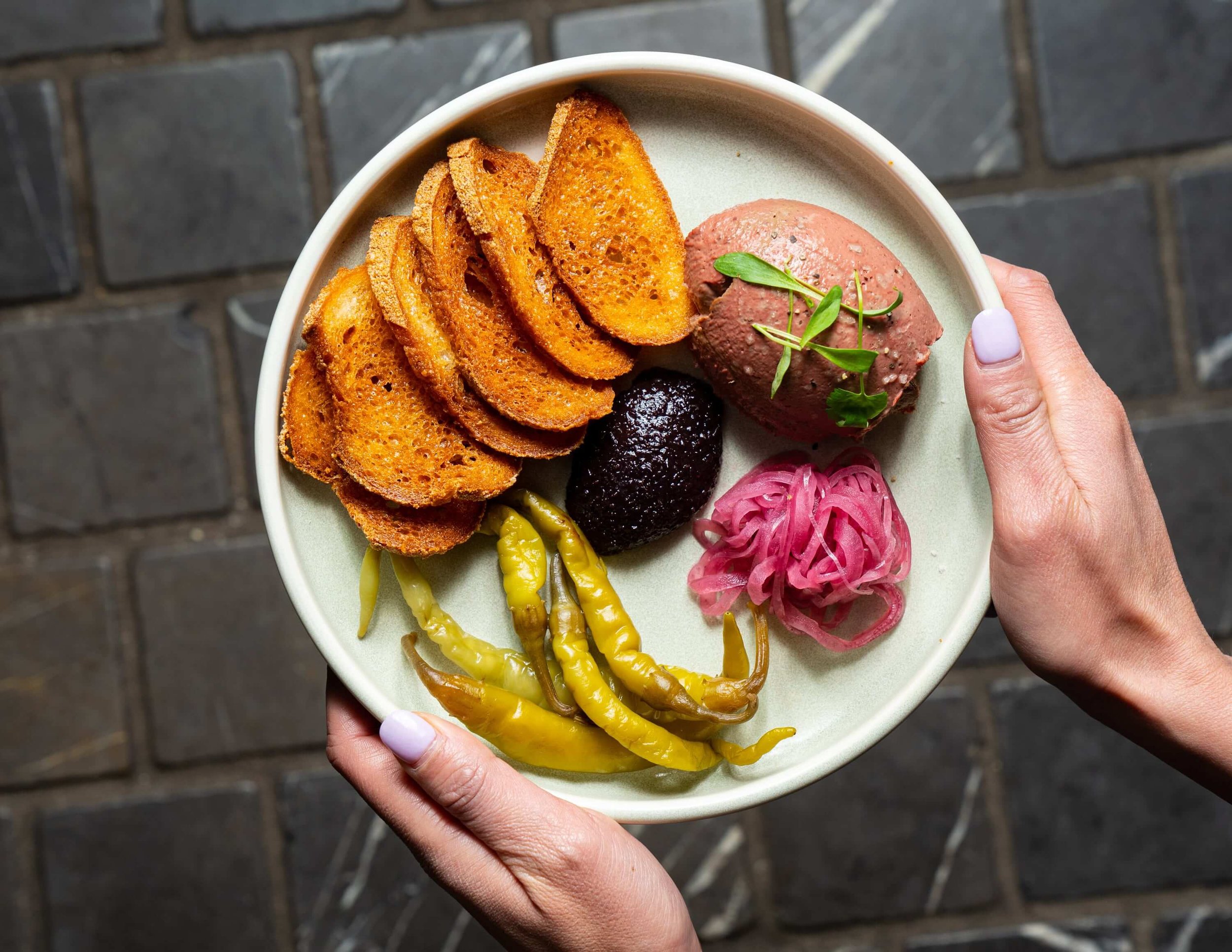 Plate full of patte and dips for an antipasto board