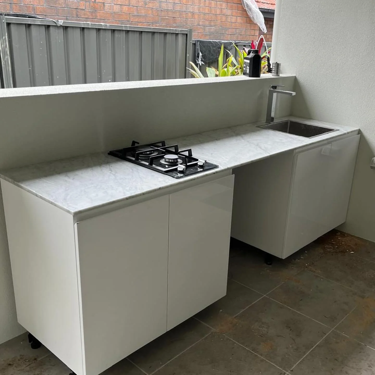 Outdoor kitchen installation with stovetop, sink and marble countertop. A most convenient addition. 
Pic taken before the clean-up 🫧