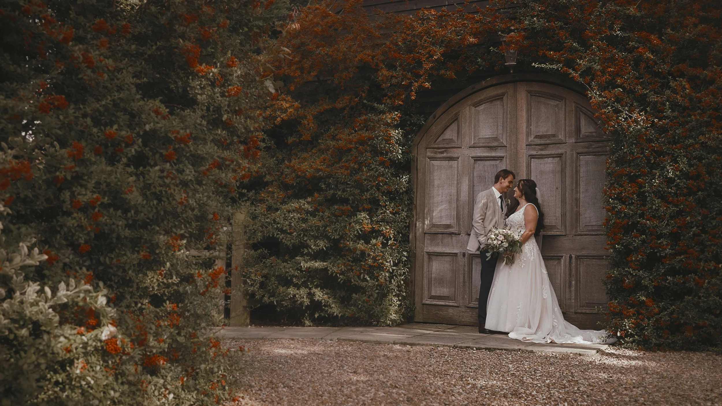 A timeless moment in a Winters Barns wedding film as the couple pose by the famous barn doors.