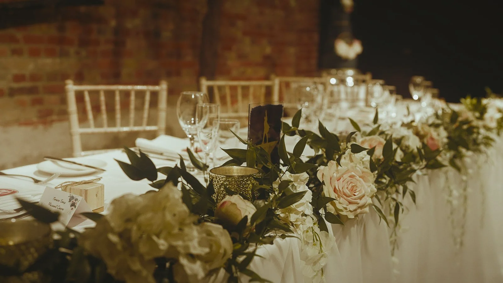 Top table decor and setup in the Tithe Barn at Cooling Castle Barn wedding venue.