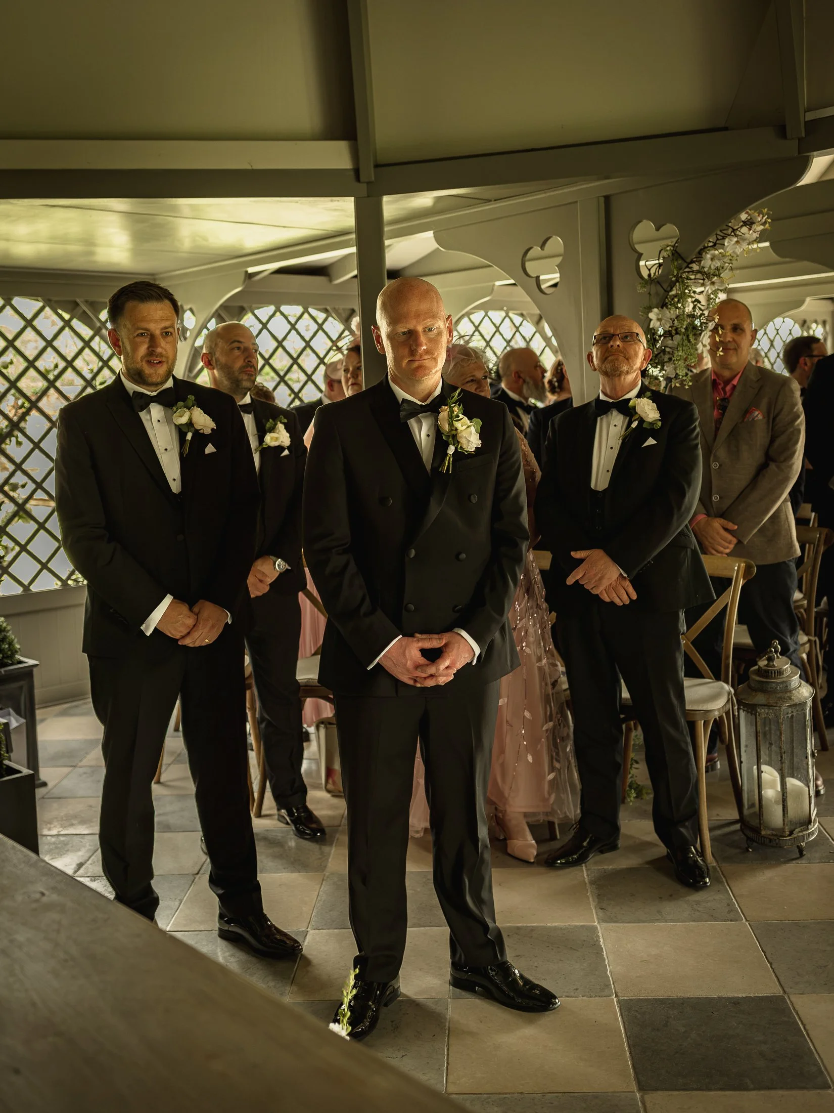 Groom waits at the end of the aisle during his wedding ceremony at Port Lympne Hotel.