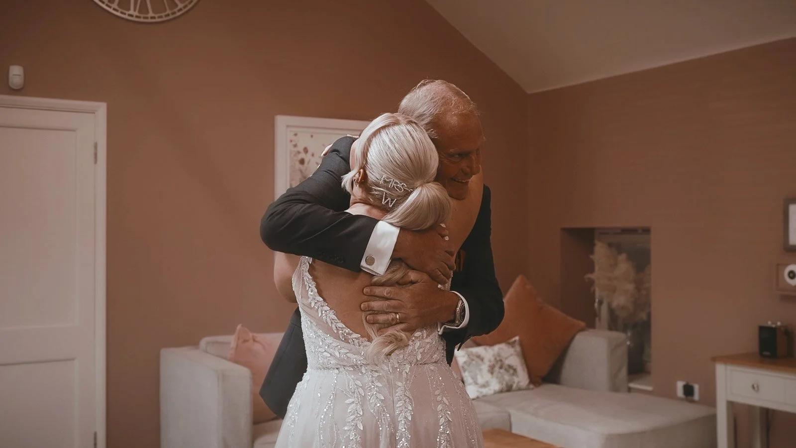 An emotional moment as a Bride hugs her Father during a wedding dress reveal in the salon at Winters Barns in Kent.