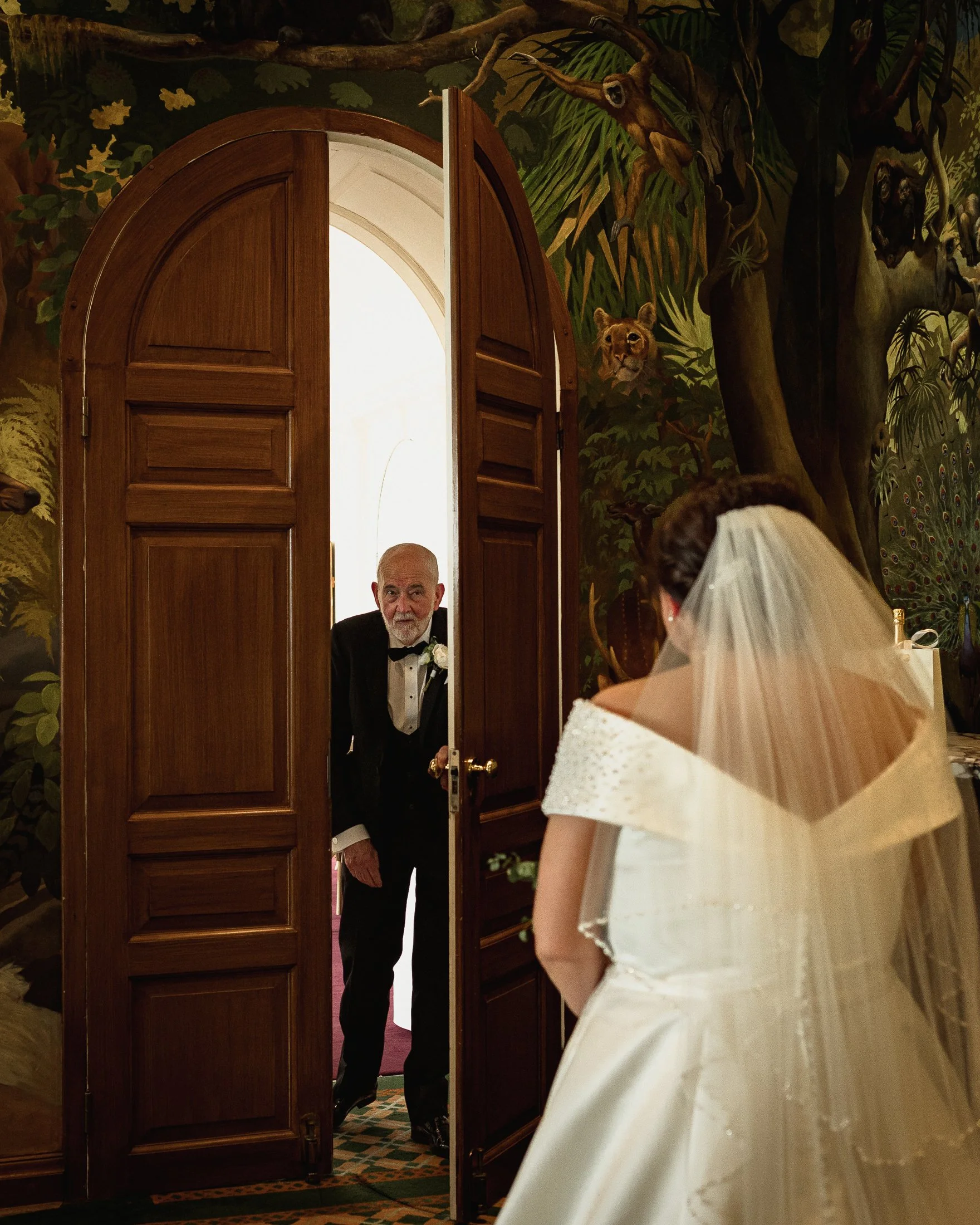 Father of the Bride sees his daughter in her wedding dress for the first time at Port Lympne Hotel.