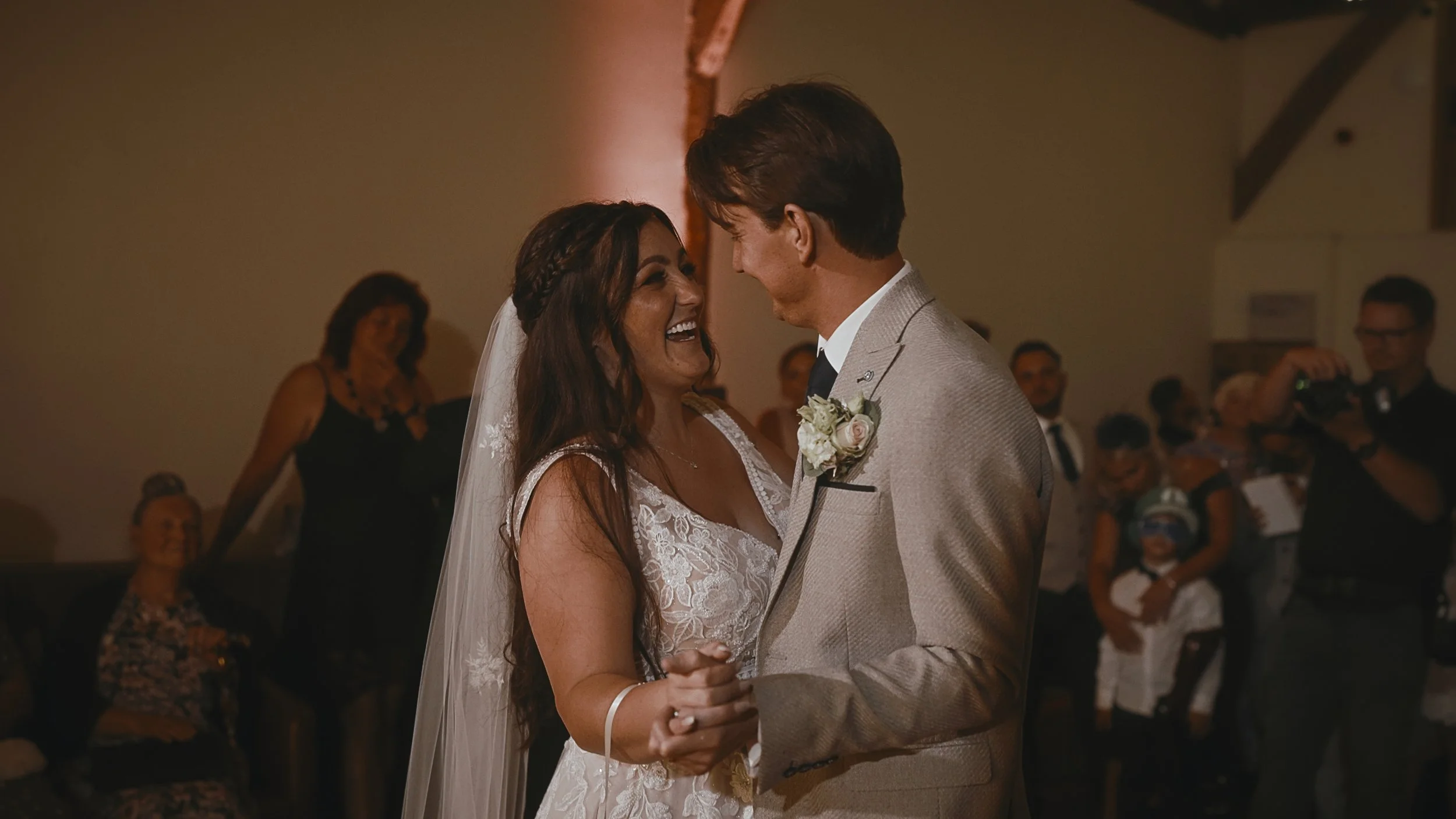 A bride and groom laughing together as they share their first dance at Winters Barns.