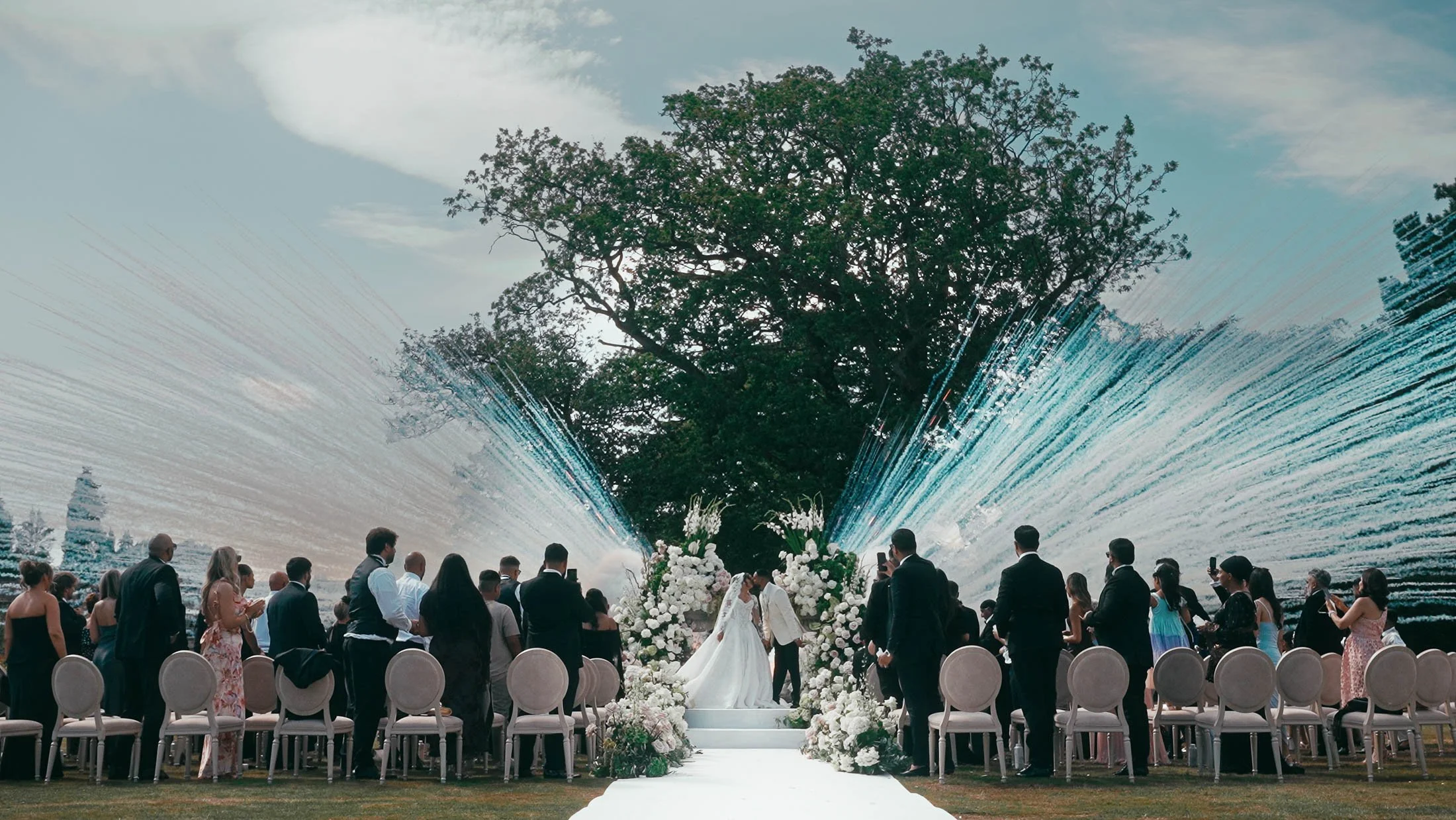 Daytime fireworks exploding during an outdoor wedding ceremony at Grantley Hall, Yorkshire.