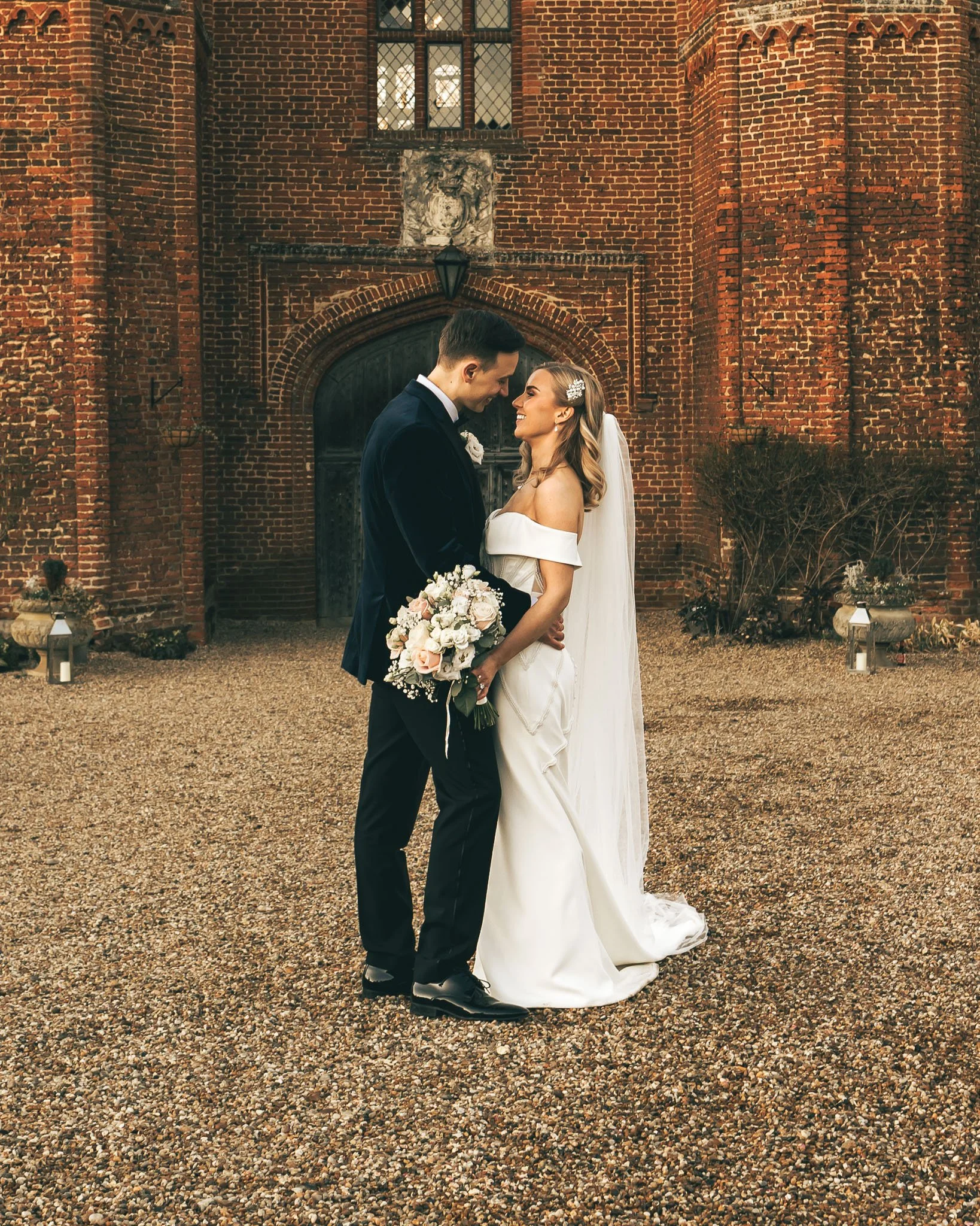 Bride holding bouquet, elegant portrait with editorial lighting