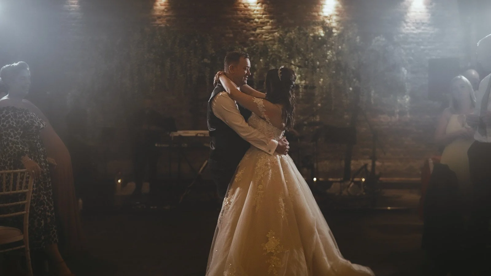 A bride and groom share their first dance in the Tithe barn in a Cooling Castle wedding film.