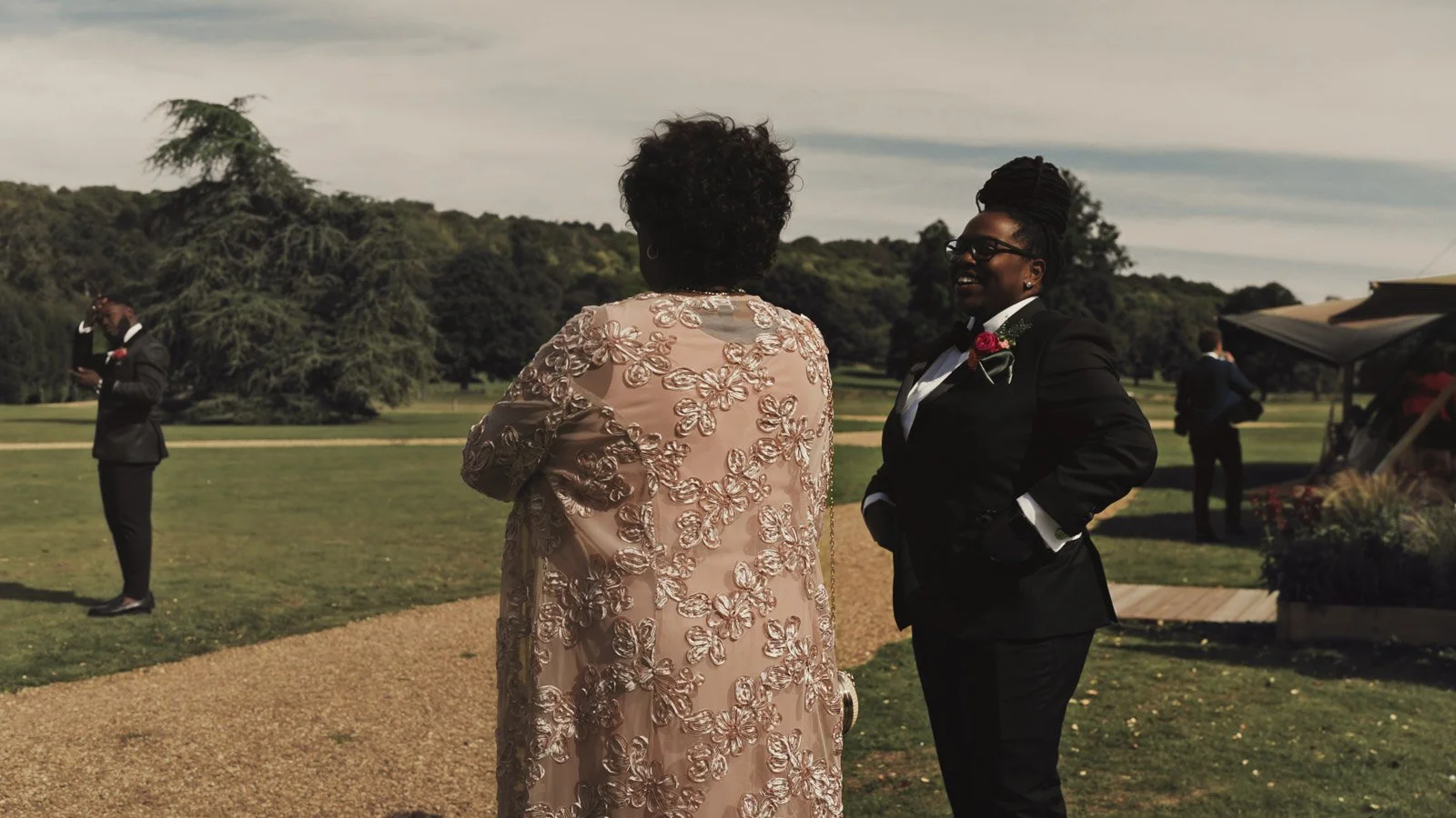 Guests and atmosphere from a colourful riverside wedding with black-tie styling and a marquee party on the Thames.