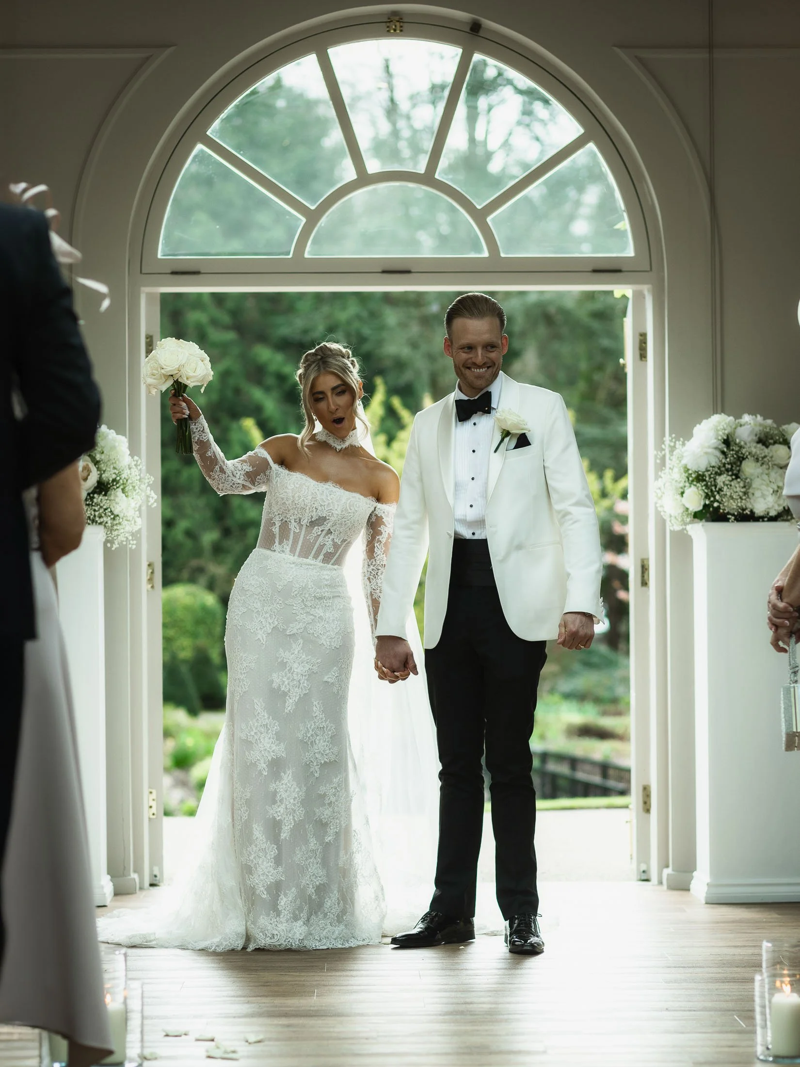 A couple celebrate during their indoor wedding ceremony at The Orangery Maidstone in Kent.