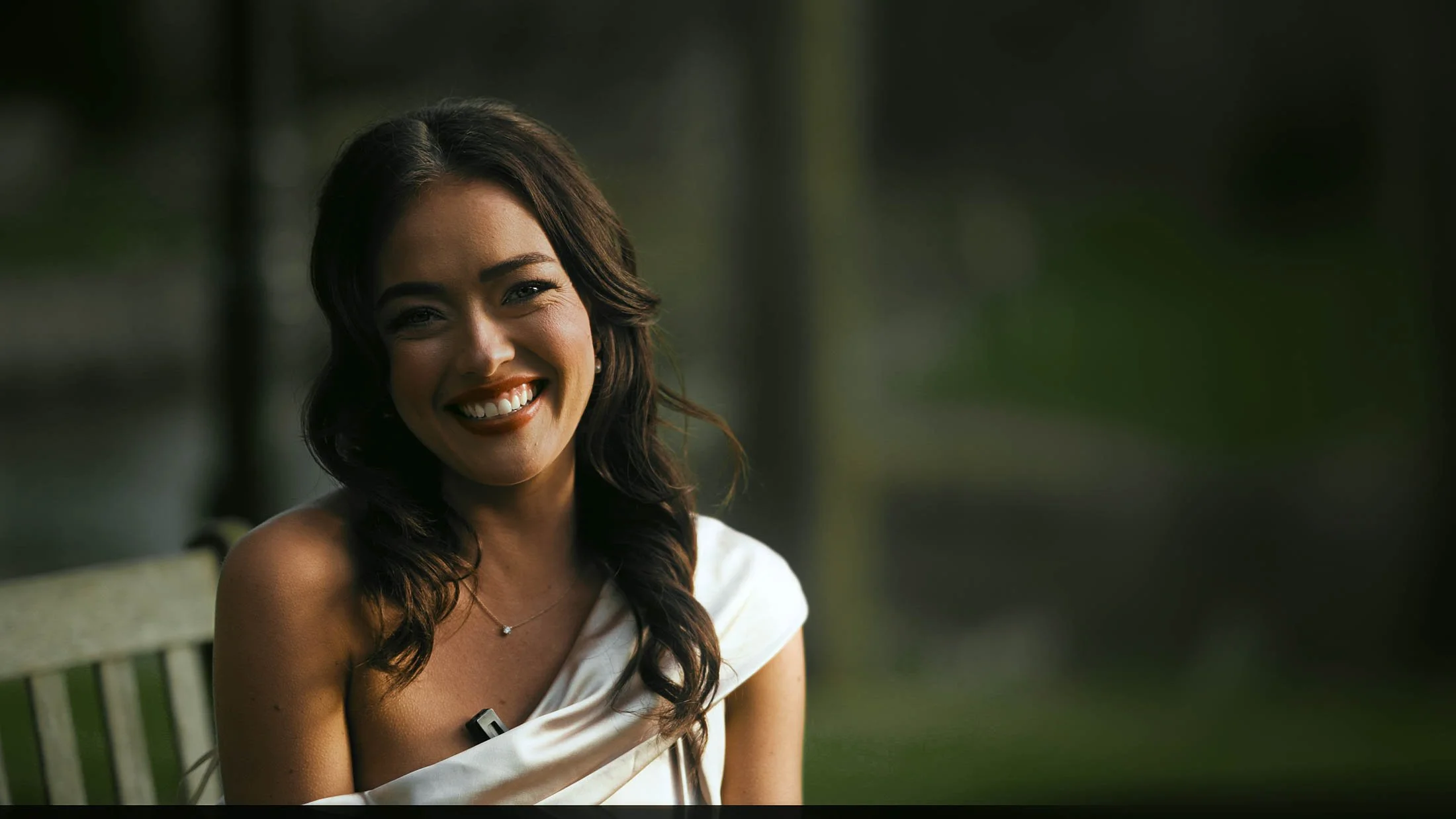 A bridesmaid smiles at the camera as she is interviewed on the wedding day, providing personal and emotive narrative for a storytelling wedding film.