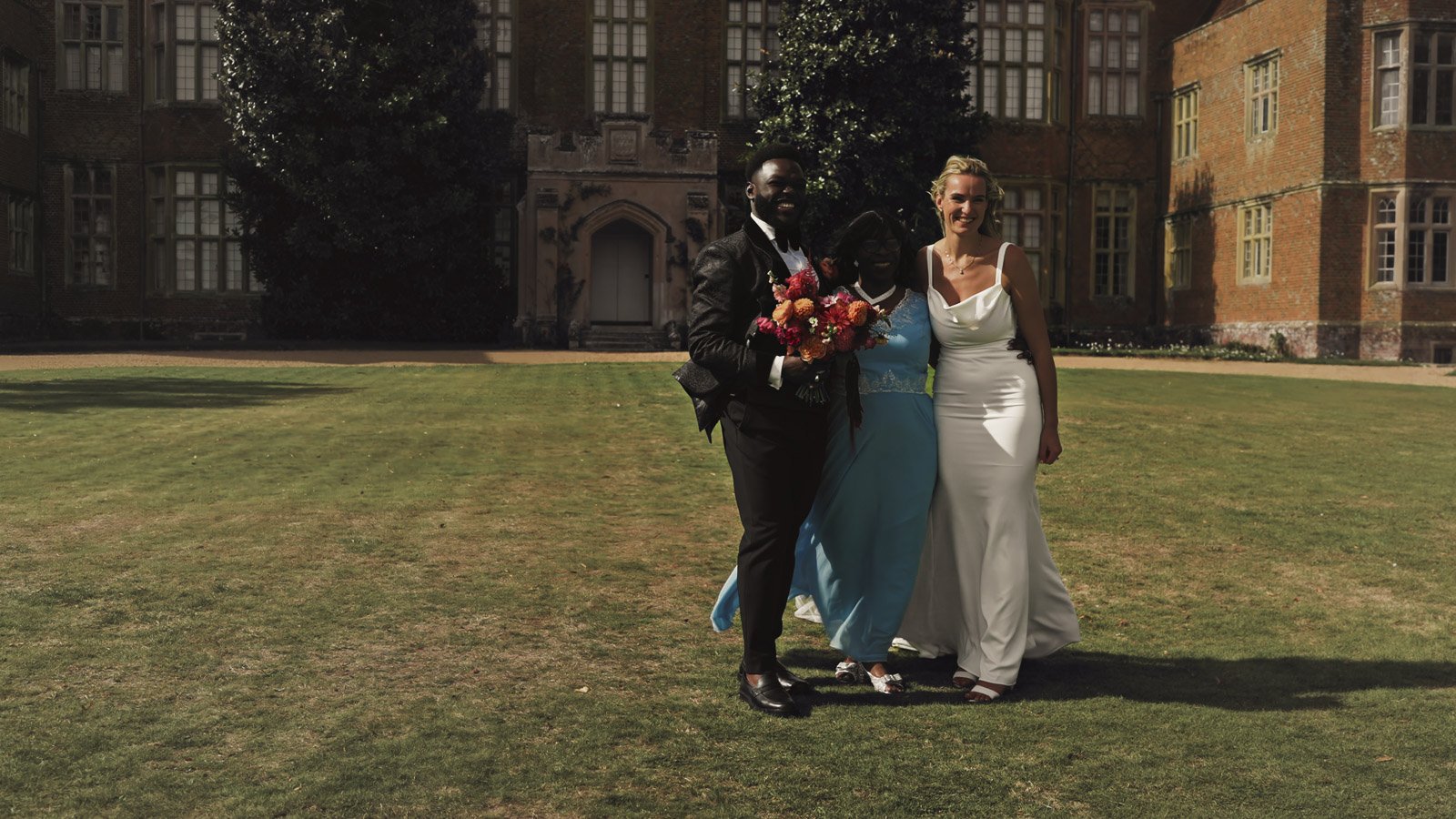Editorial-style wedding photography from a colourful riverside celebration with bold florals and a marquee reception.