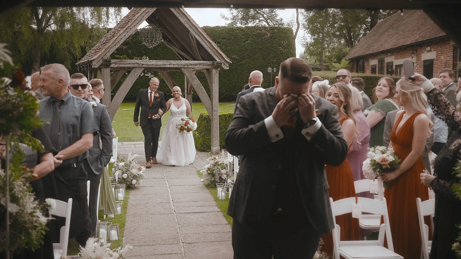 An emotional outdoor wedding ceremony as the groom cries as he sees his bride at Winters Barns in Canterbury, Kent