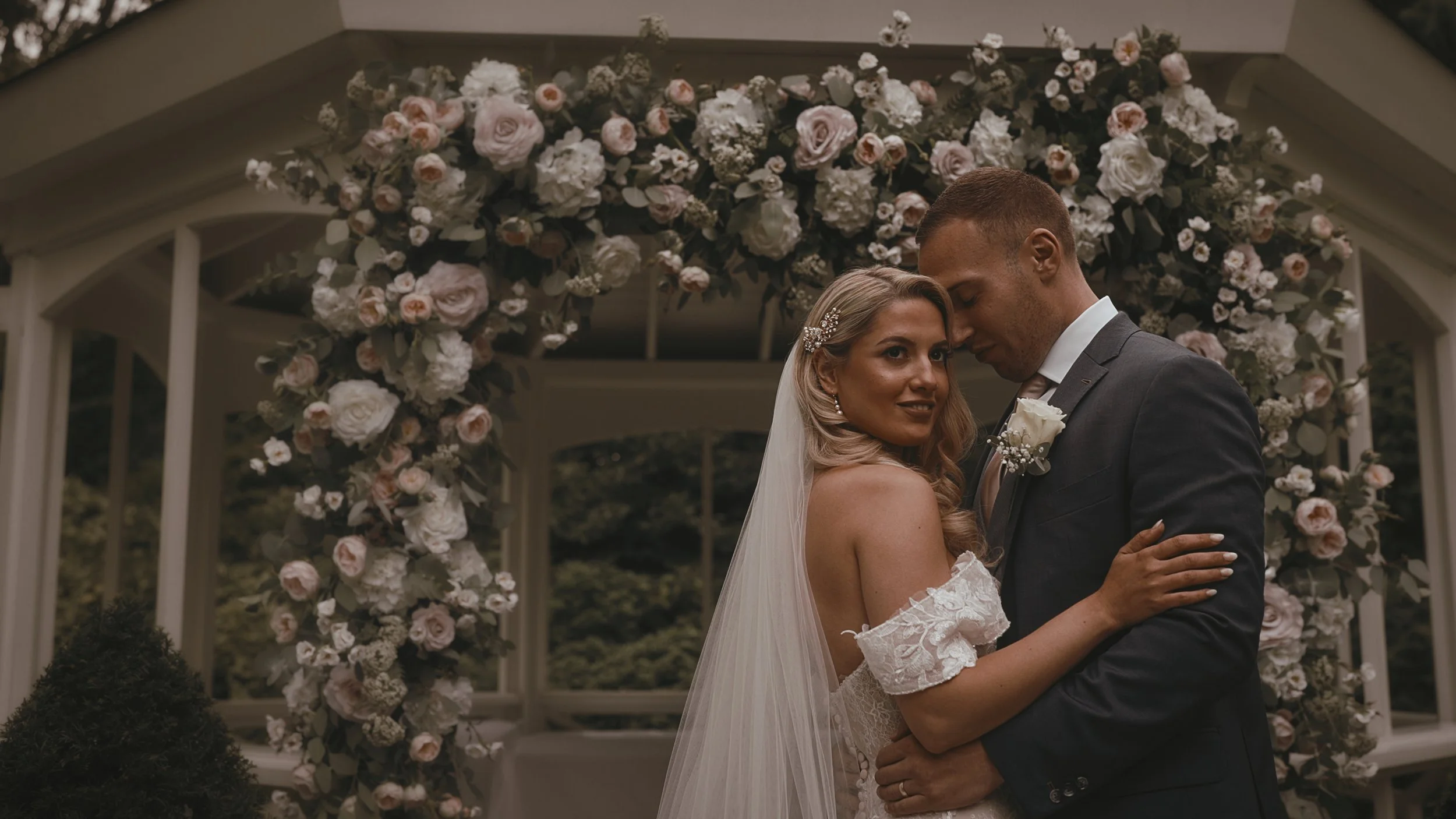 Bride and groom laughing together during outdoor summer wedding portraits at The Orangery Maidstone in Kent