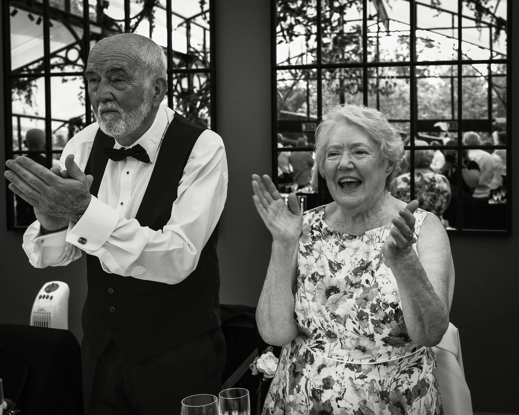 Guests react and laugh as the bride and groom are announced into the wedding reception.