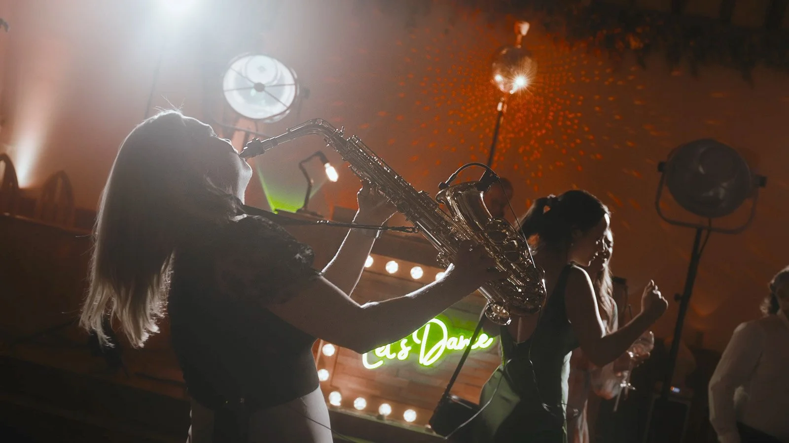 A saxophone player on the dance floor at a Winters Barns wedding in Kent.
