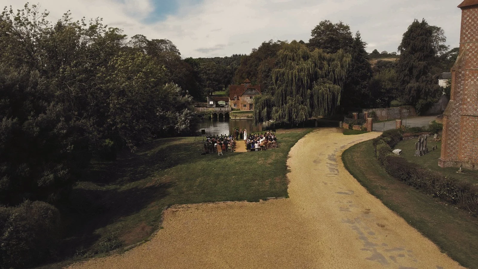 An aerial shot taken during an outdoor wedding ceremony on the banks of the River Thames.